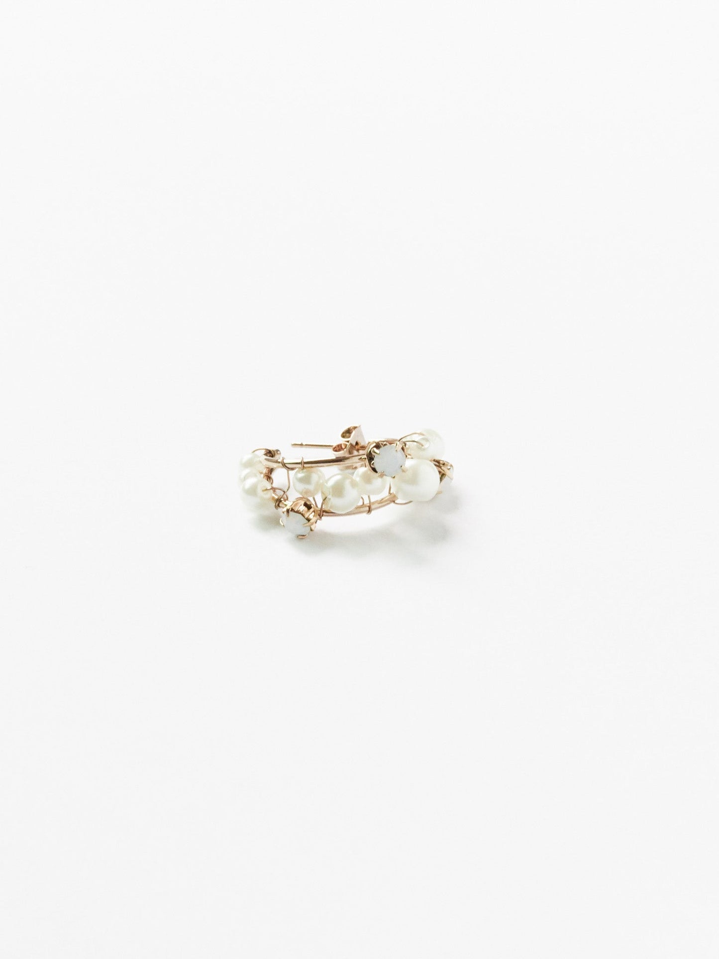 Gold ring with pearls on a white background
