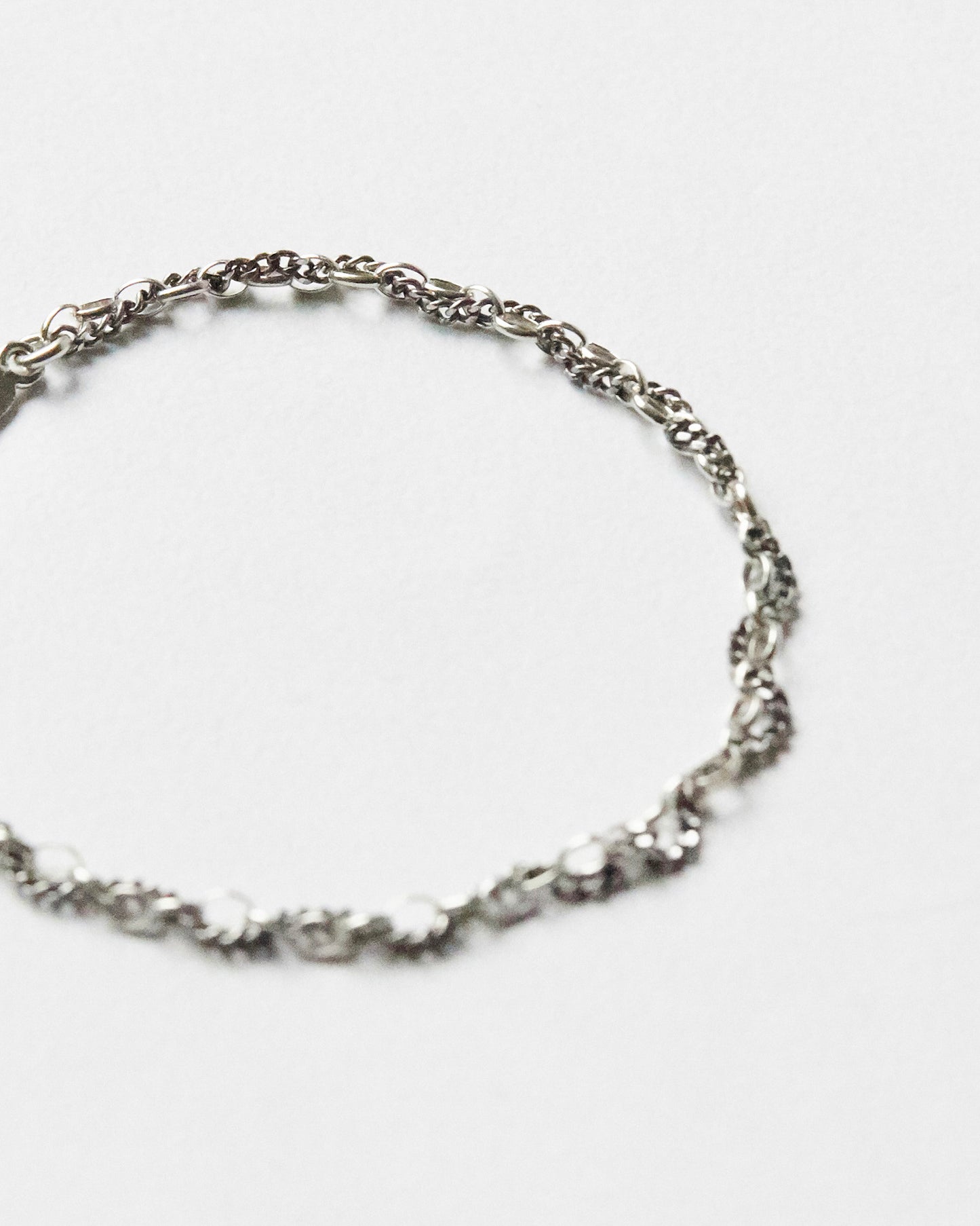 Detailed view of textured sterling silver mixed-link bracelet chain