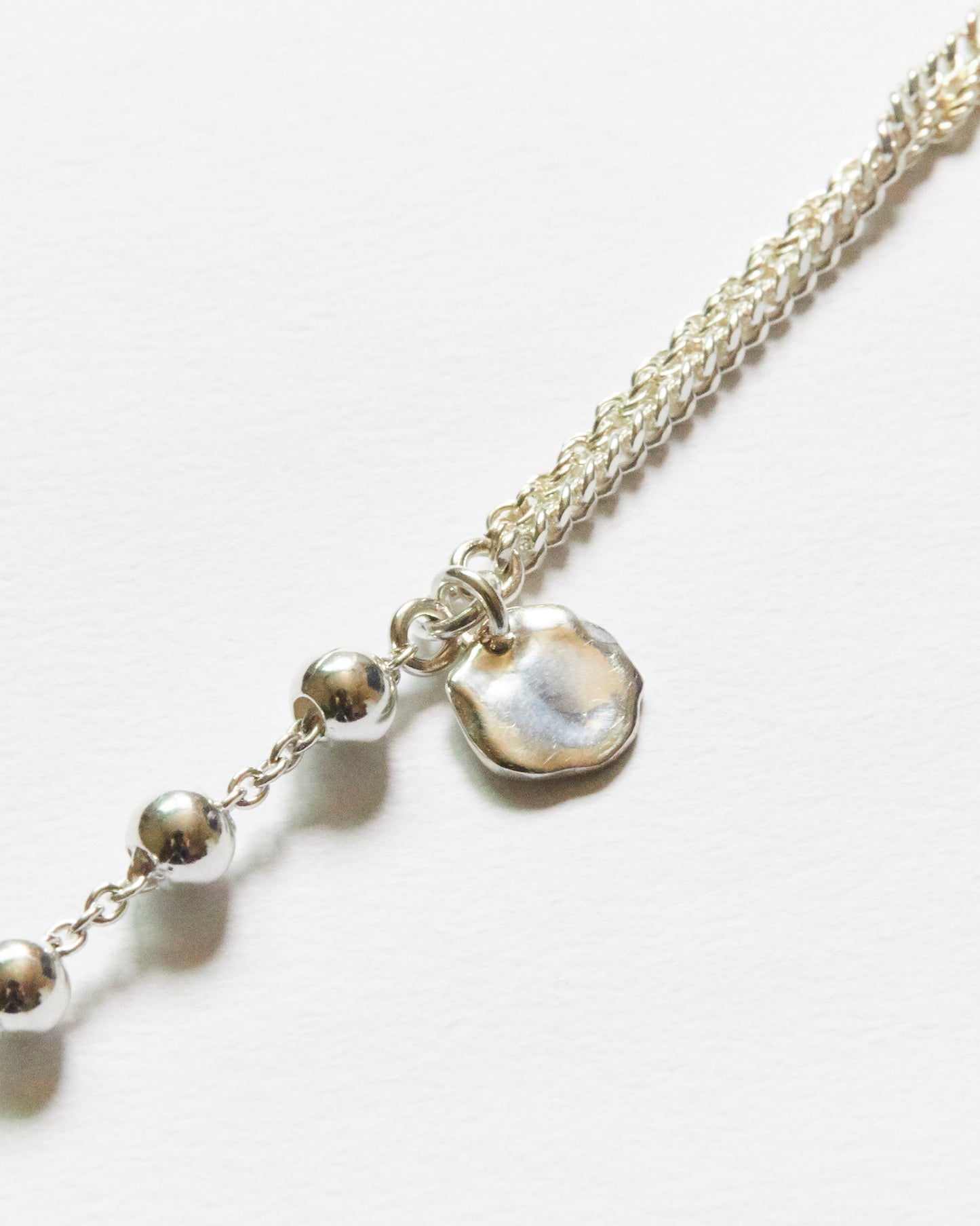 close up silver bead chain bracelet with organic charm detail minimal texture jewelry