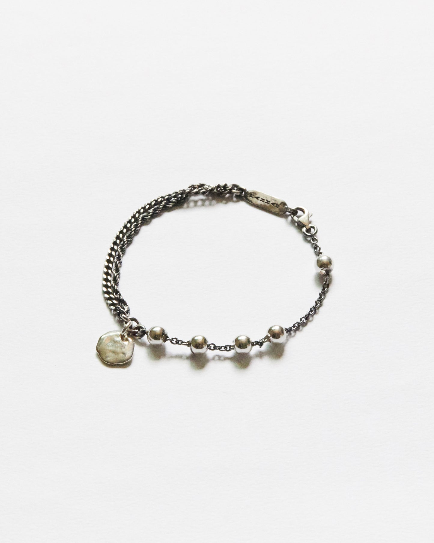 antique silver bracelet with beads on a white background
