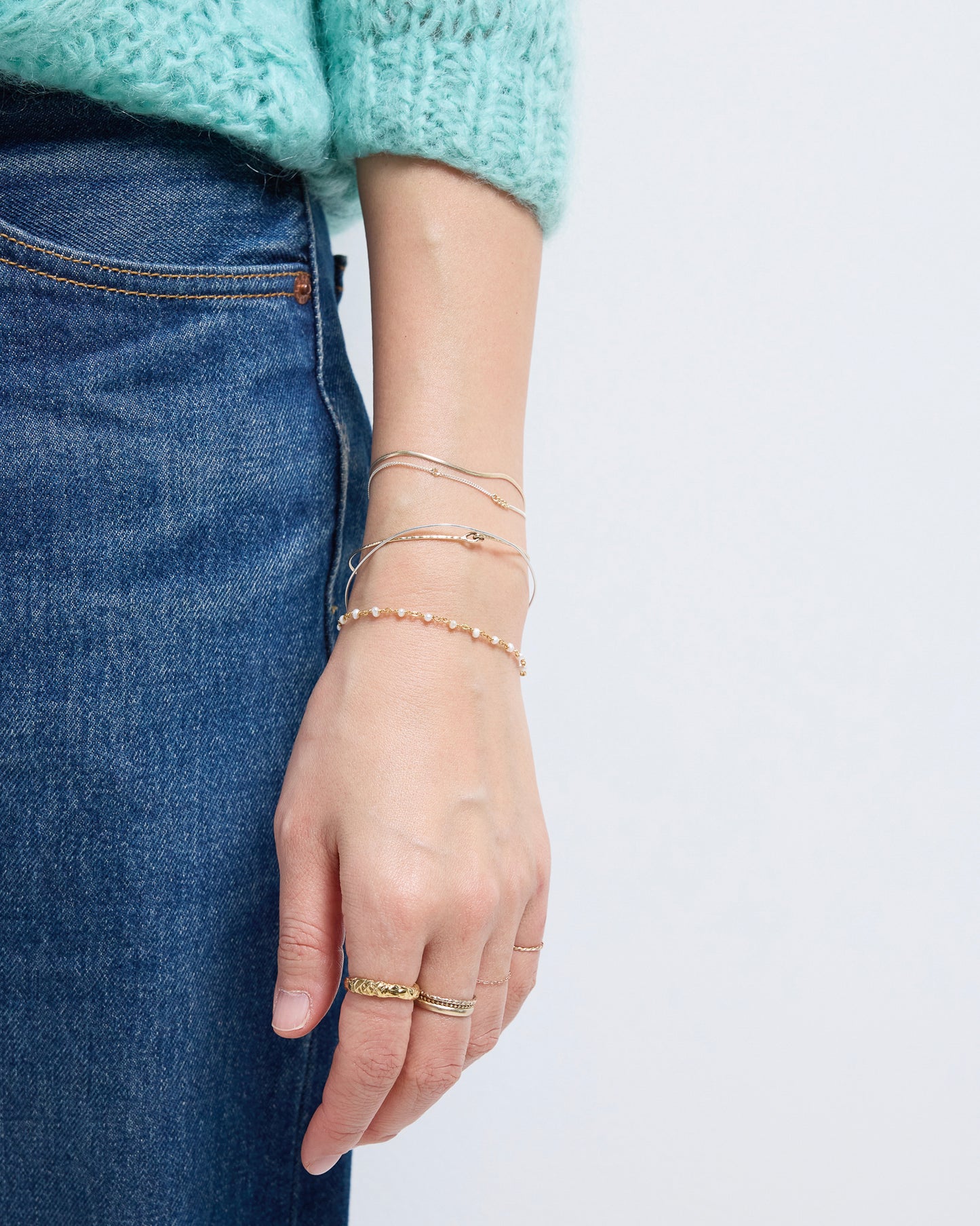 Delicate gold pearl bracelet styled casually with denim outfit