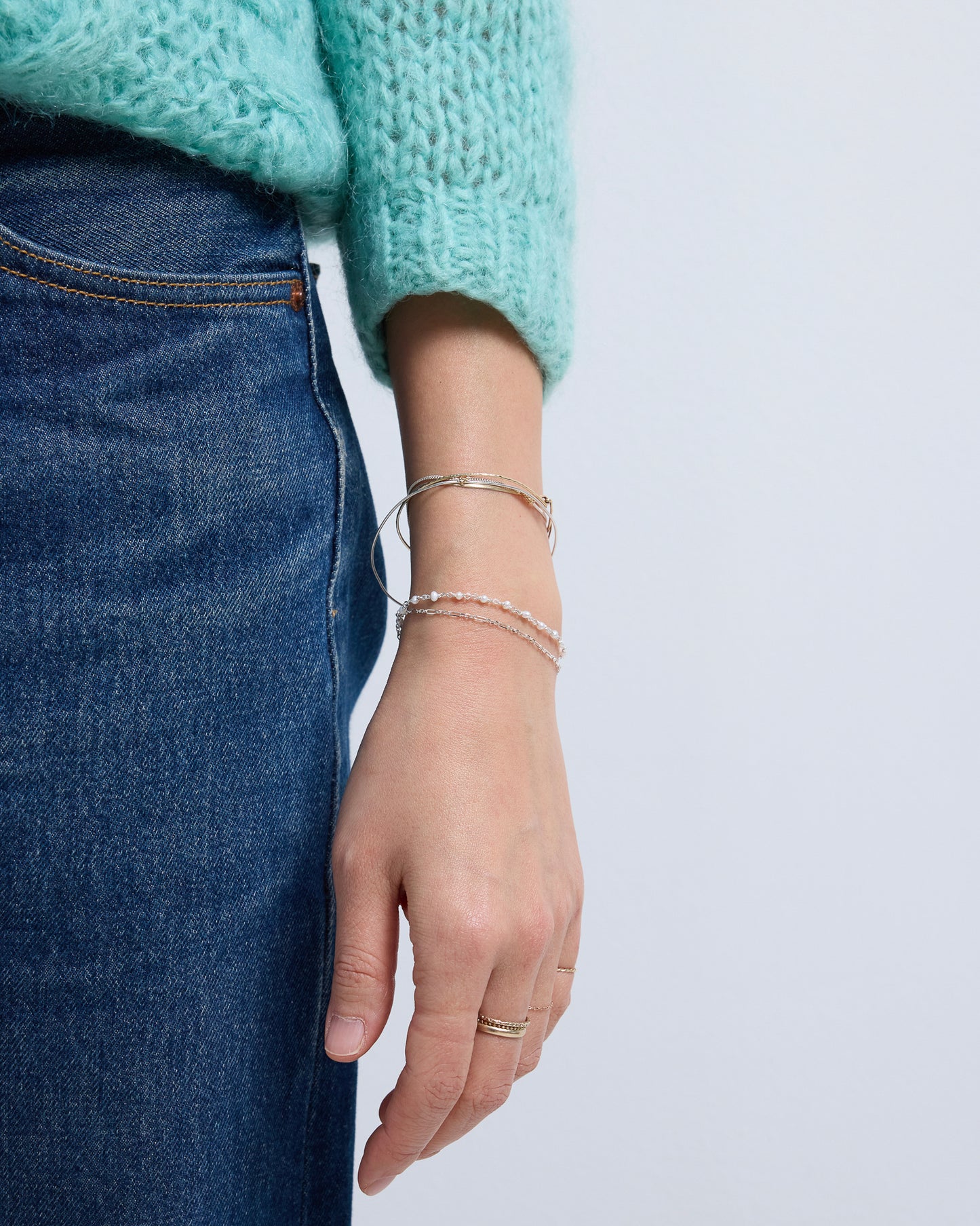 Silver layered pearl bracelet styled with stacked bracelets and denim outfit for everyday wear