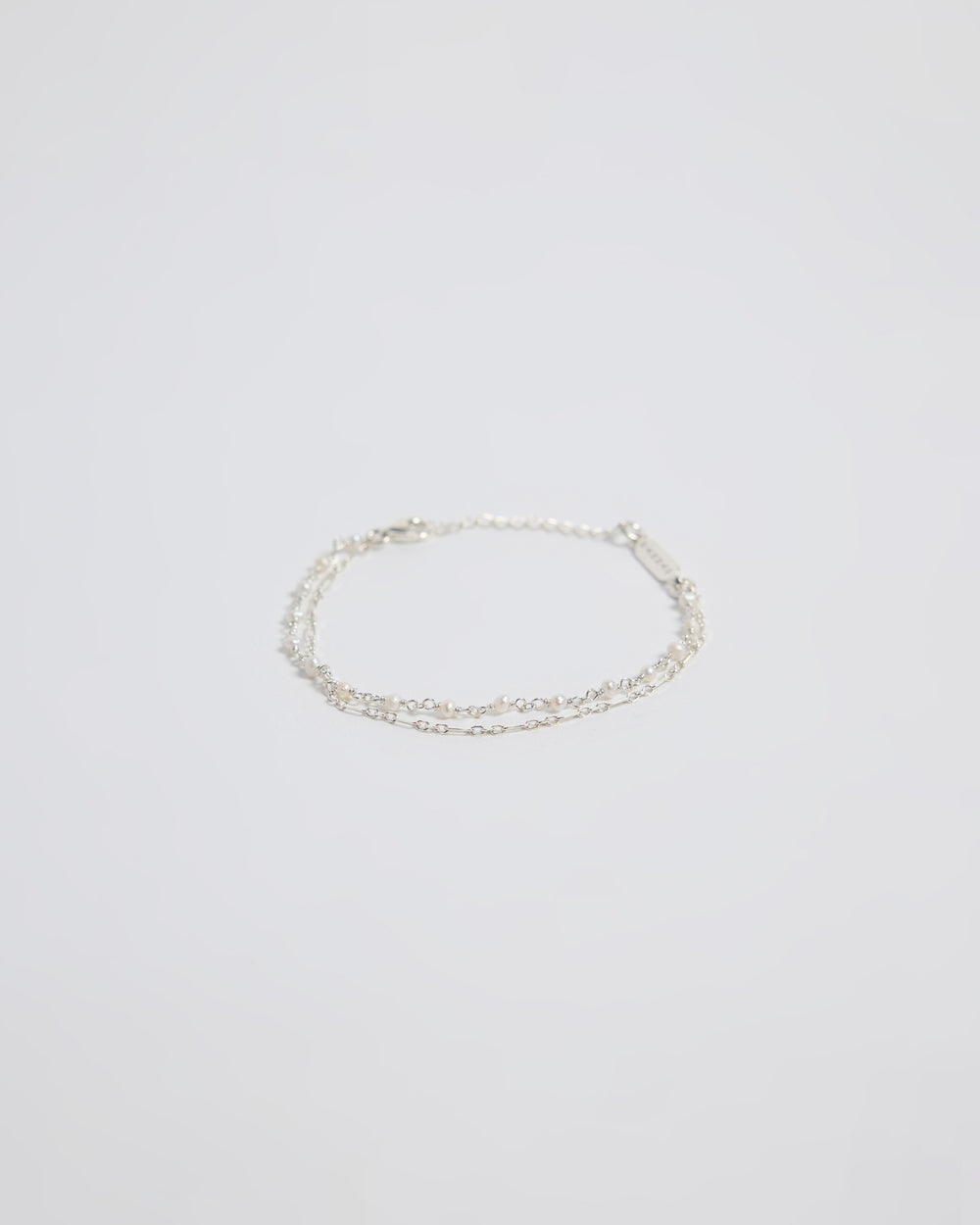 Minimal silver double layered pearl bracelet isolated on white background