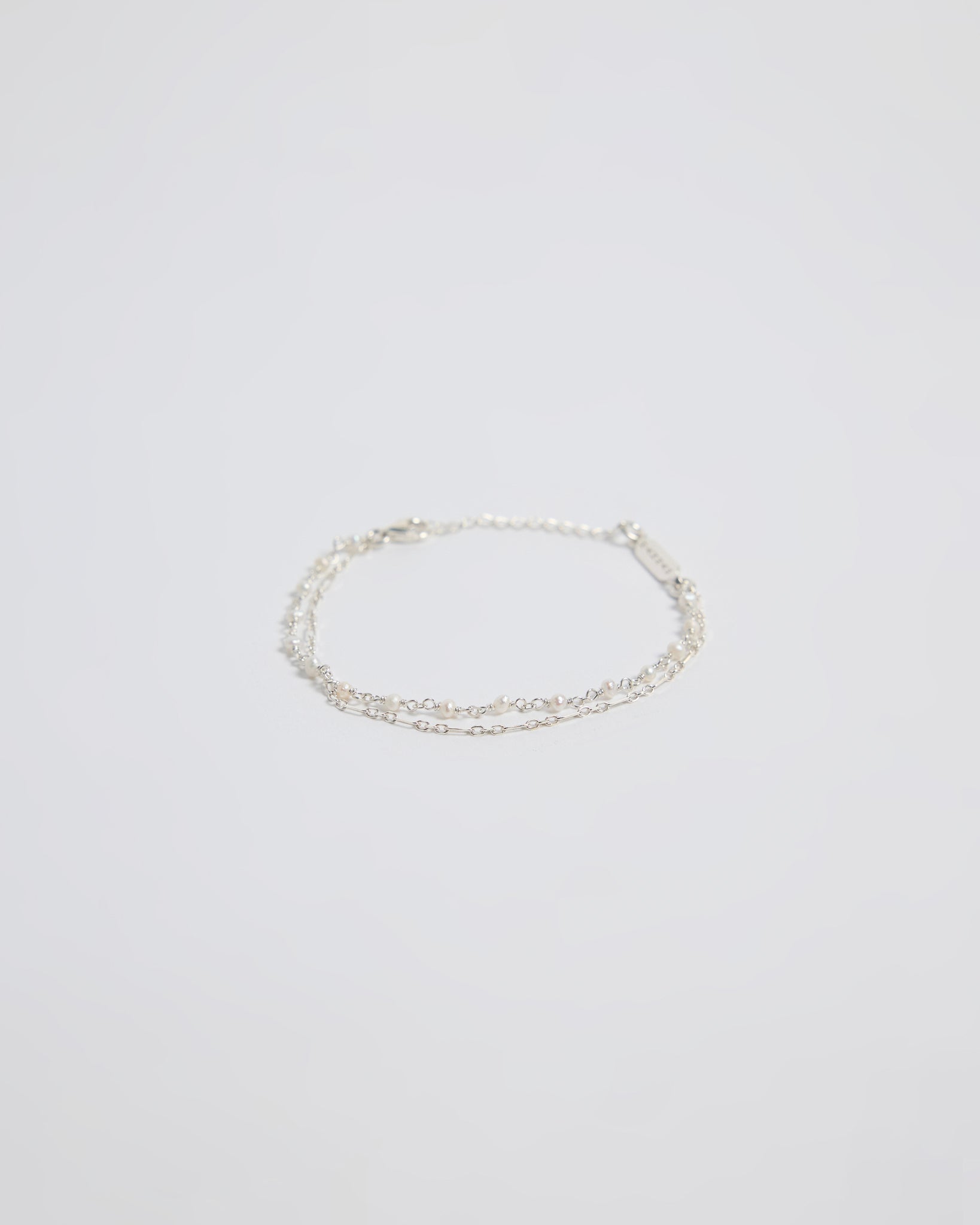 Minimal silver double layered pearl bracelet isolated on white background