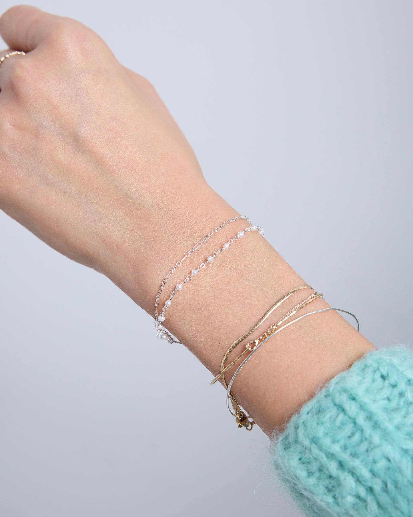 Silver double layered pearl bracelet worn on wrist, delicate minimalist everyday jewelry styling