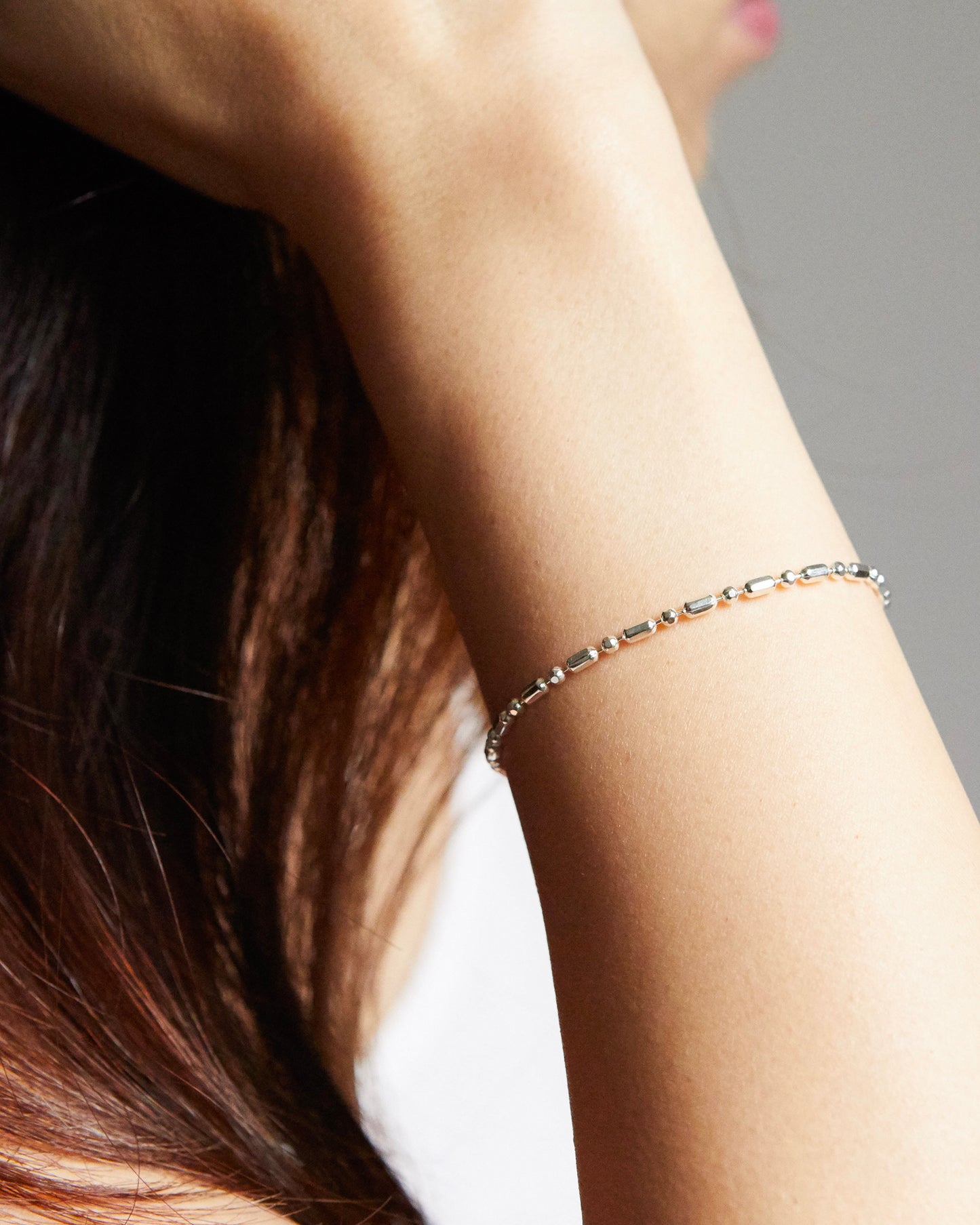 architectural silver bracelet worn on wrist, clean geometry and lightweight structure