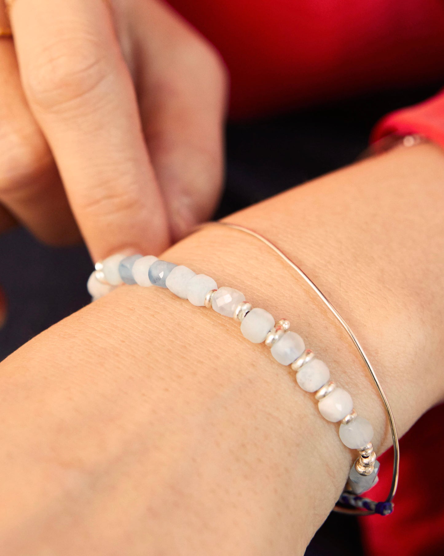 Bracelet styled on wrist, paired with minimal silver bangle