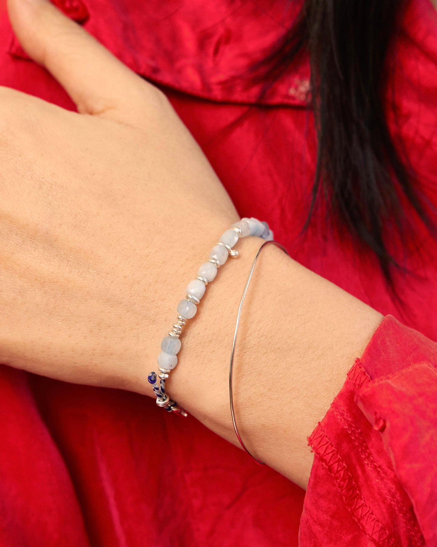 Flat-lay image of handmade bracelet showing soft blue gemstone cubes