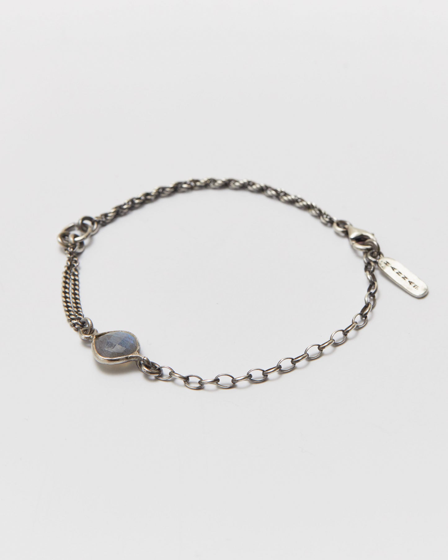 antique Silver chain bracelet with a gemstone on a light gray background