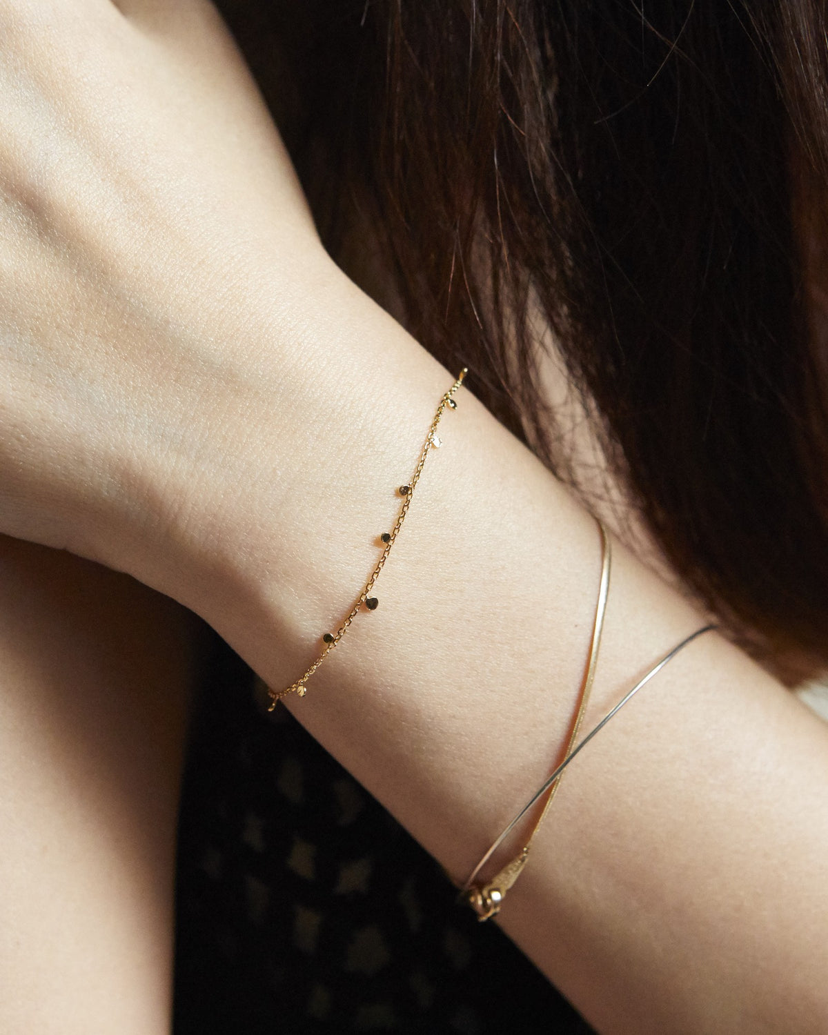 Gold dot chain bracelet stacked with fine bangles on the wrist – HANNA543 B96 dew drop garland