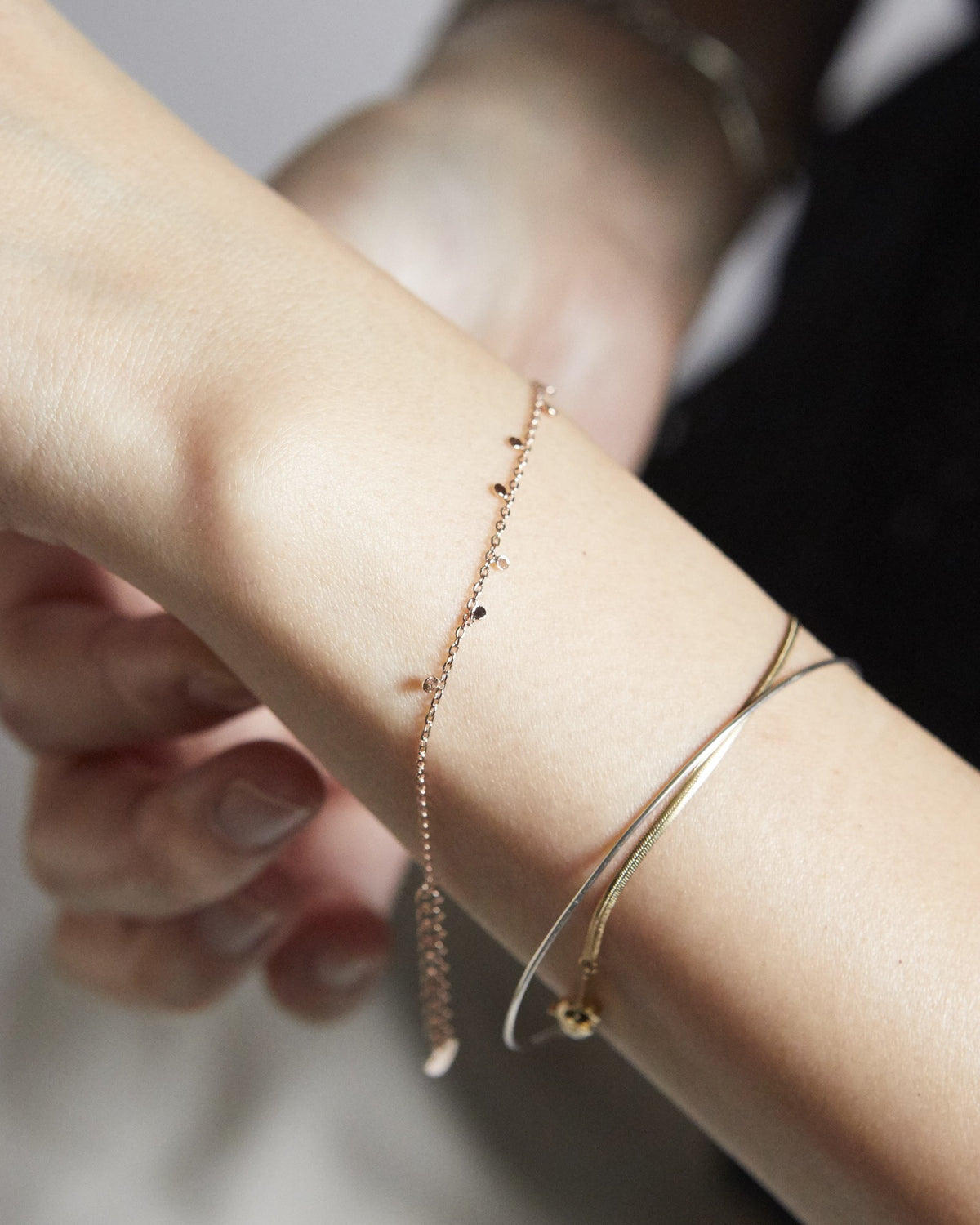 Pink gold dot chain bracelet with extender worn in a bracelet stack – HANNA543 B96 dew drop garland