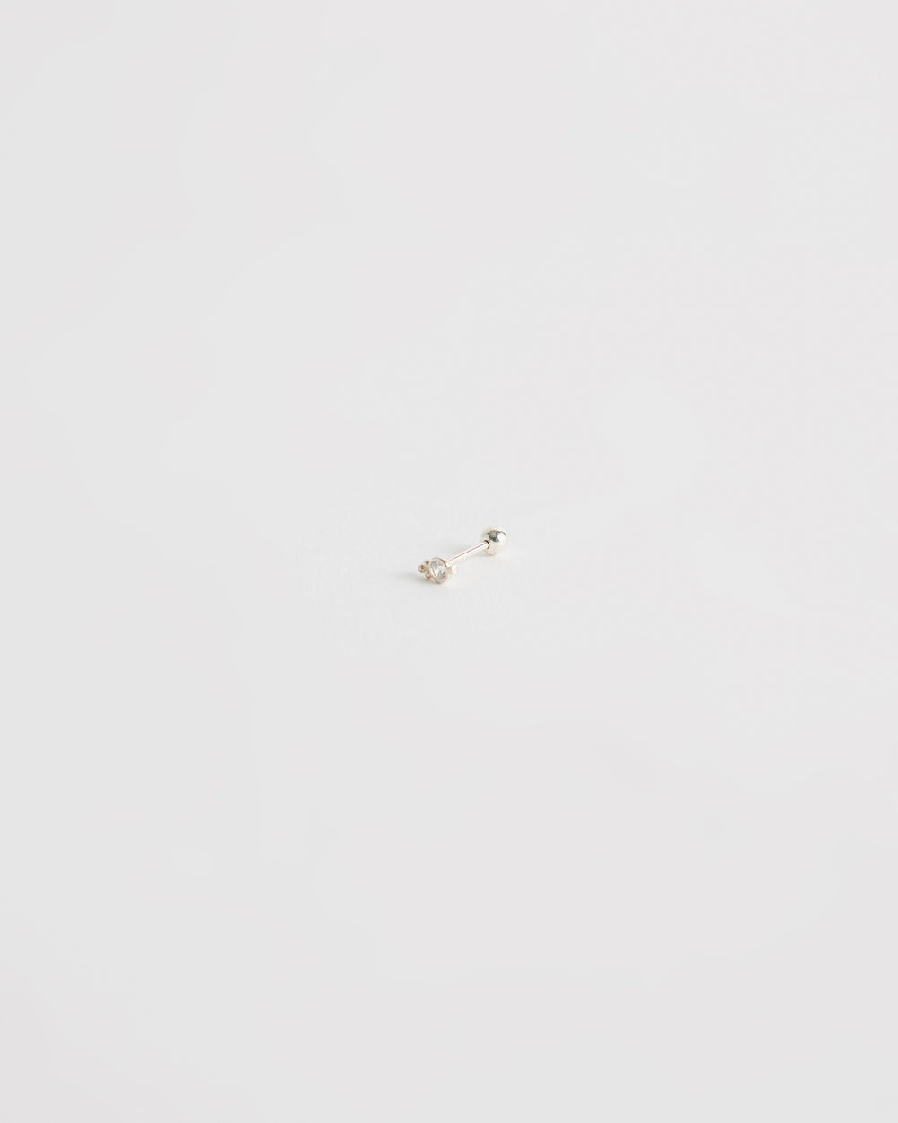 architectural silver stud earring with centered stone and minimal geometric structure