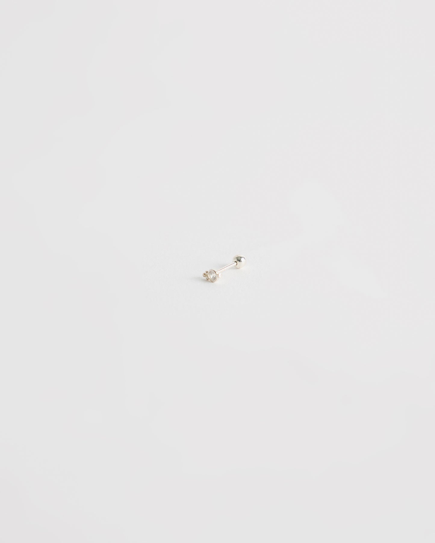 architectural silver stud earring with centered stone and minimal geometric structure