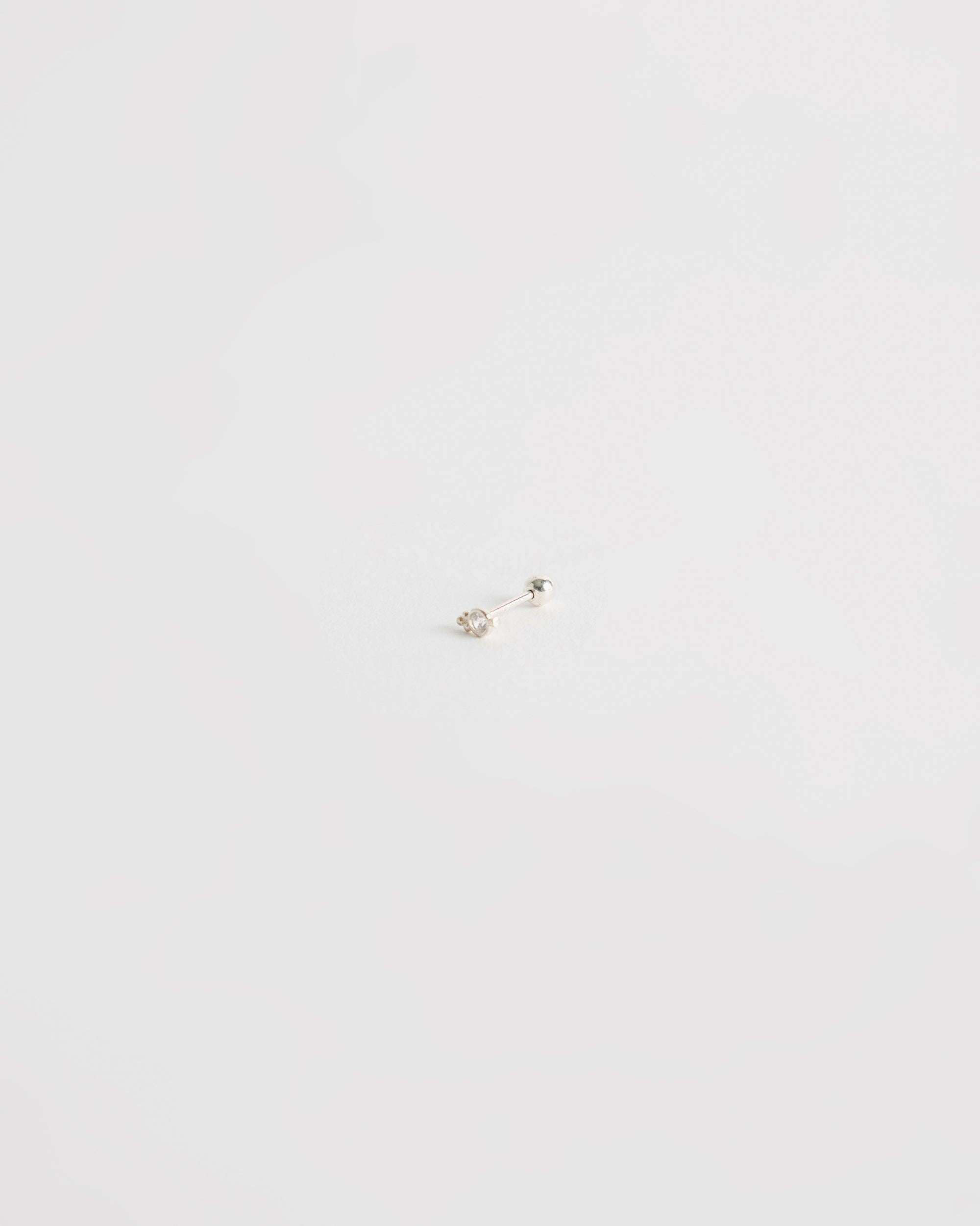 architectural silver stud earring with centered stone and minimal geometric structure