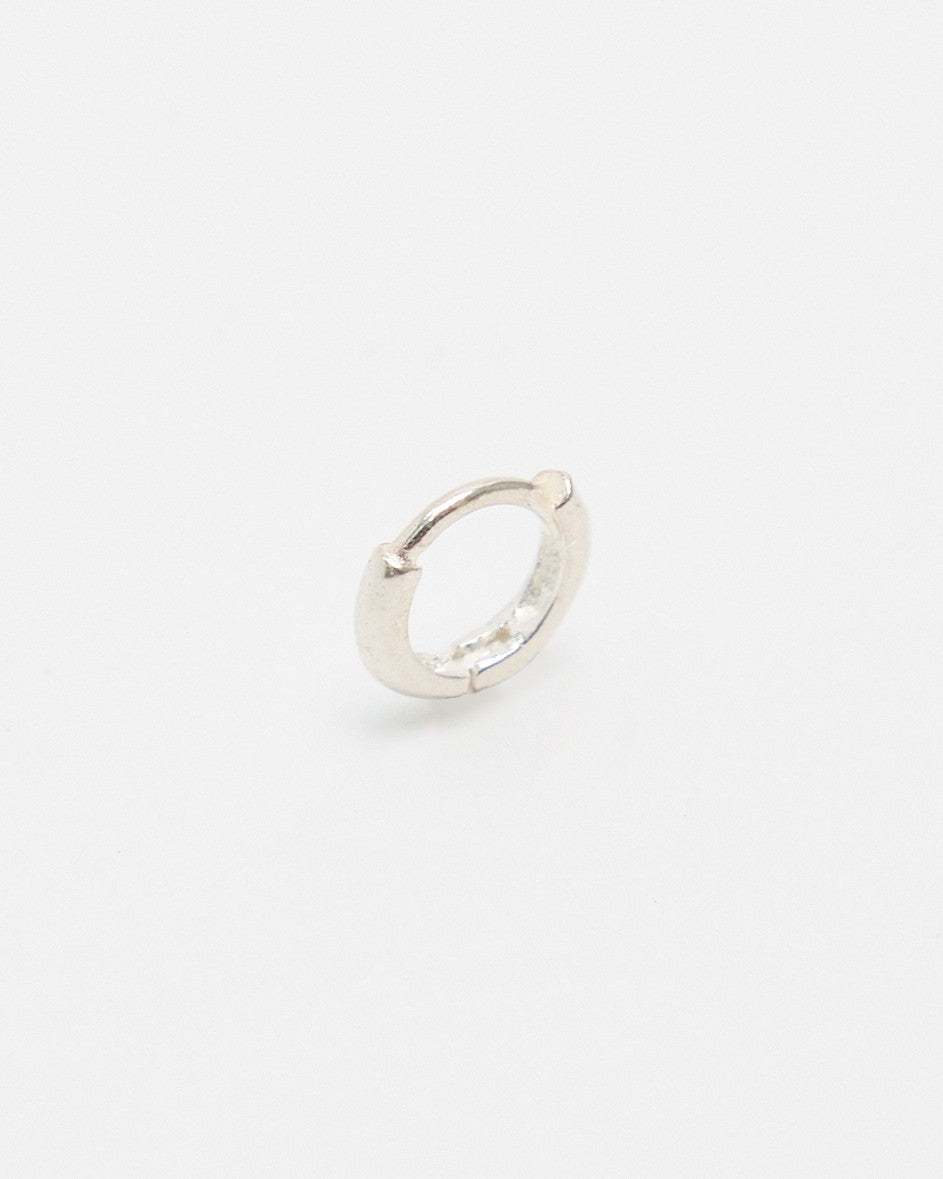 Sterling silver mini huggie hoop earring shown at an angle – HANNA543 E155 soft halo huggie