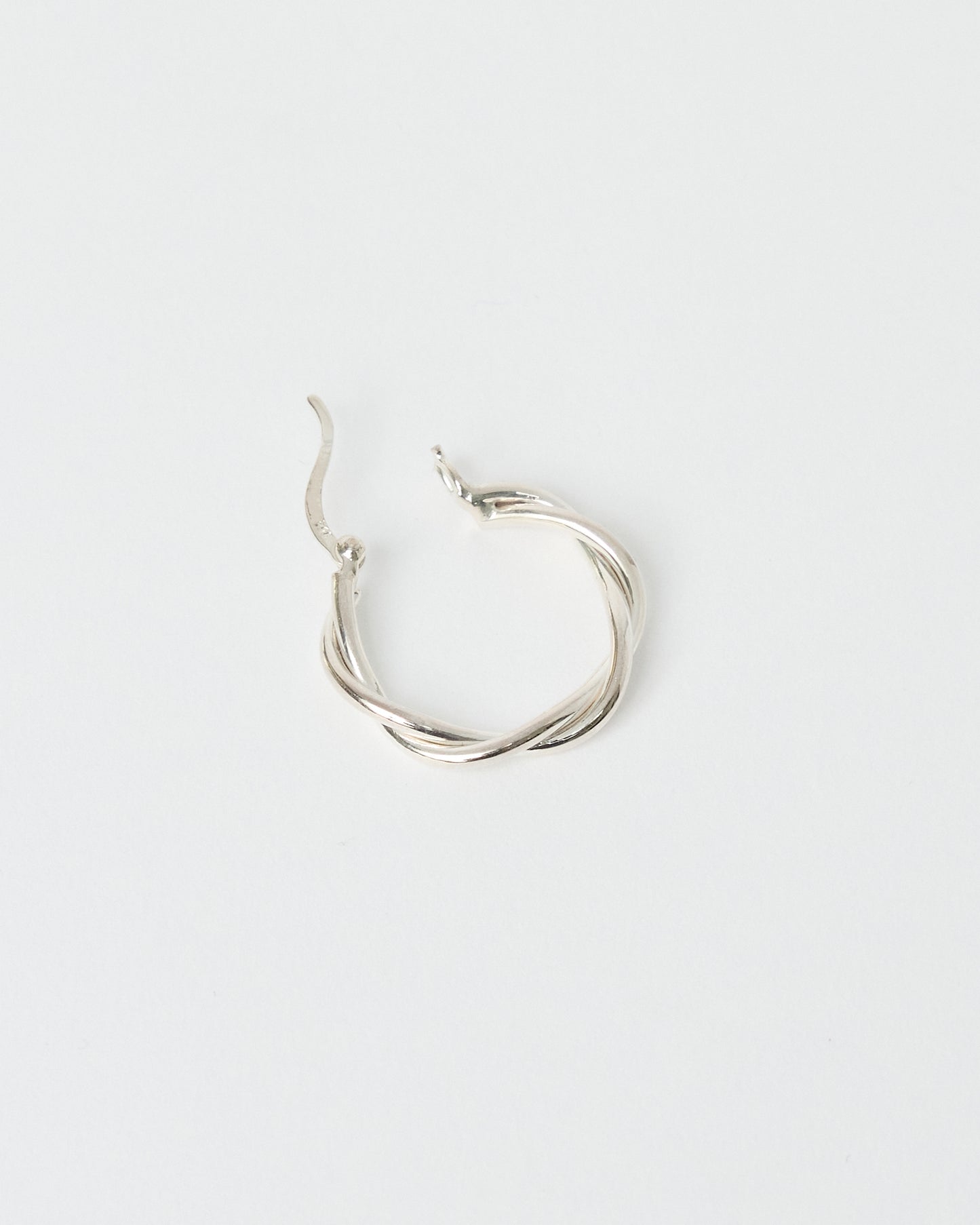 Bold Twisted Design - 925 Sterling Silver hoop earring on a light gray background