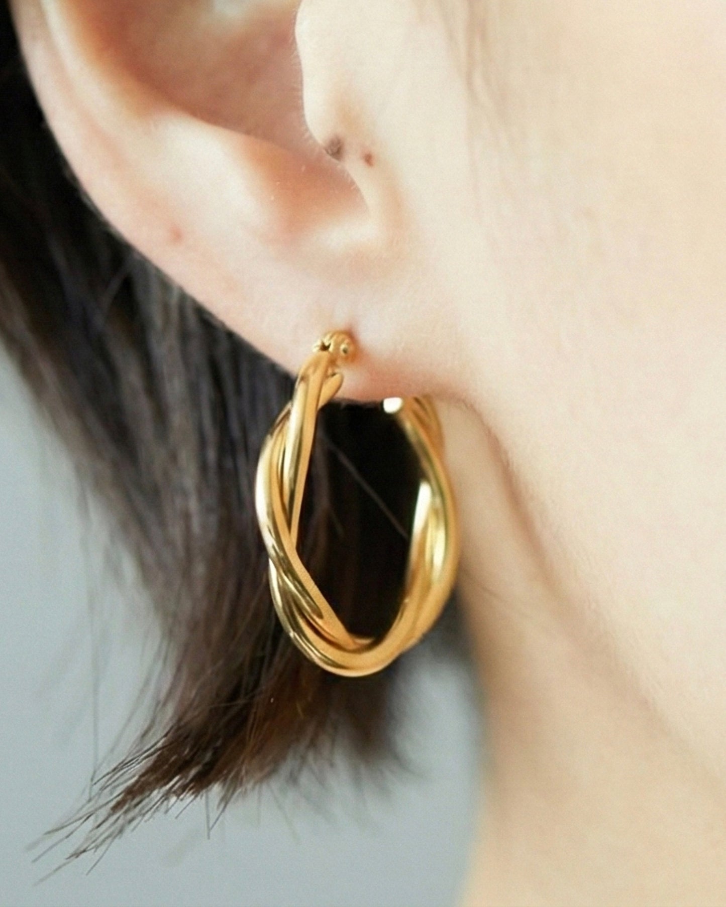 styling of HANNA543 E324 twisted gold hoop earrings on ear. daily minimalist jewelry look inspired by BTS JIMIN