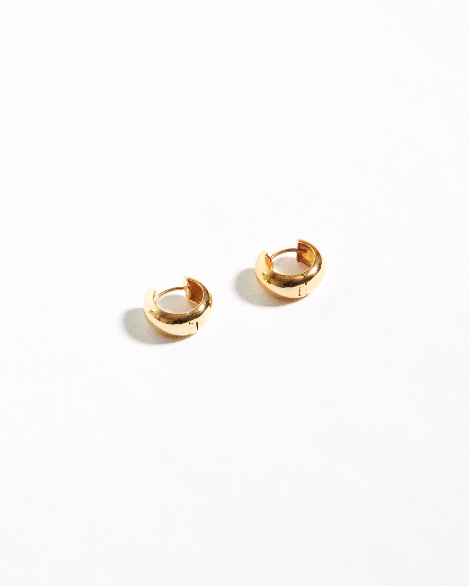 Gold hoop earrings on a white background