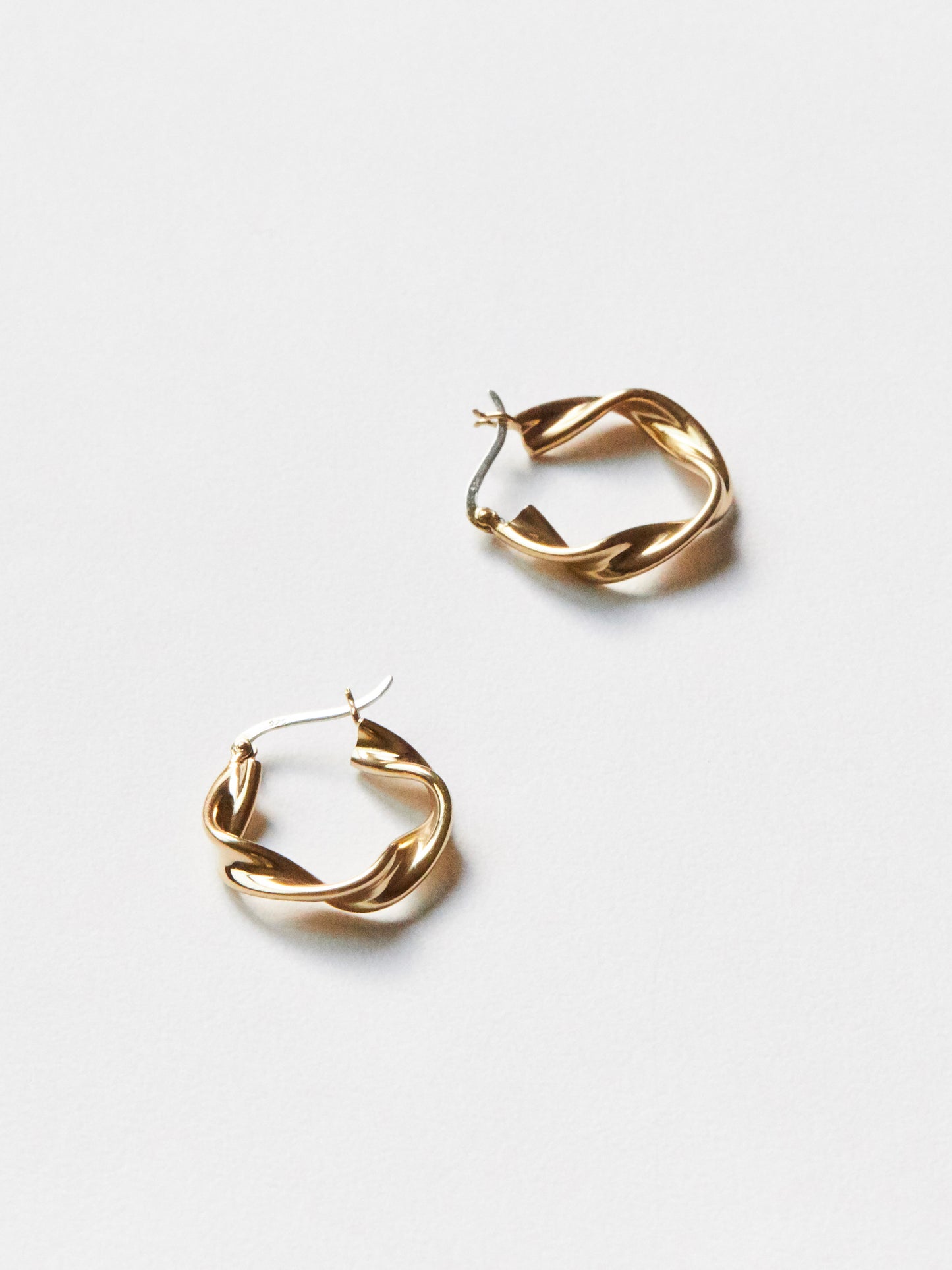 Gold hoop earrings on a white background