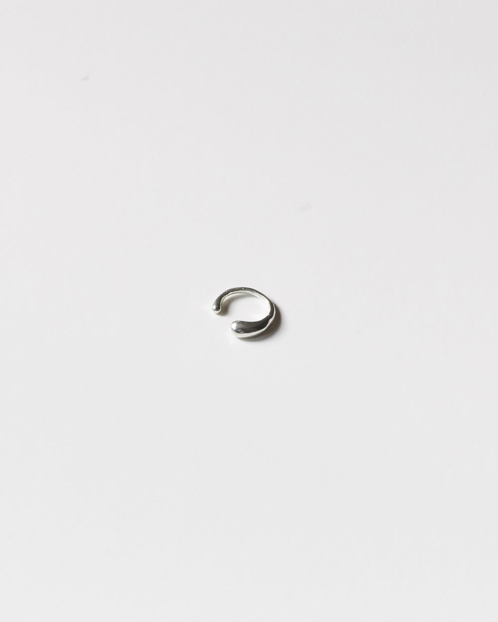Sterling silver drop ear cuff on a light gray background – HANNA543 E735 falling drop cuff