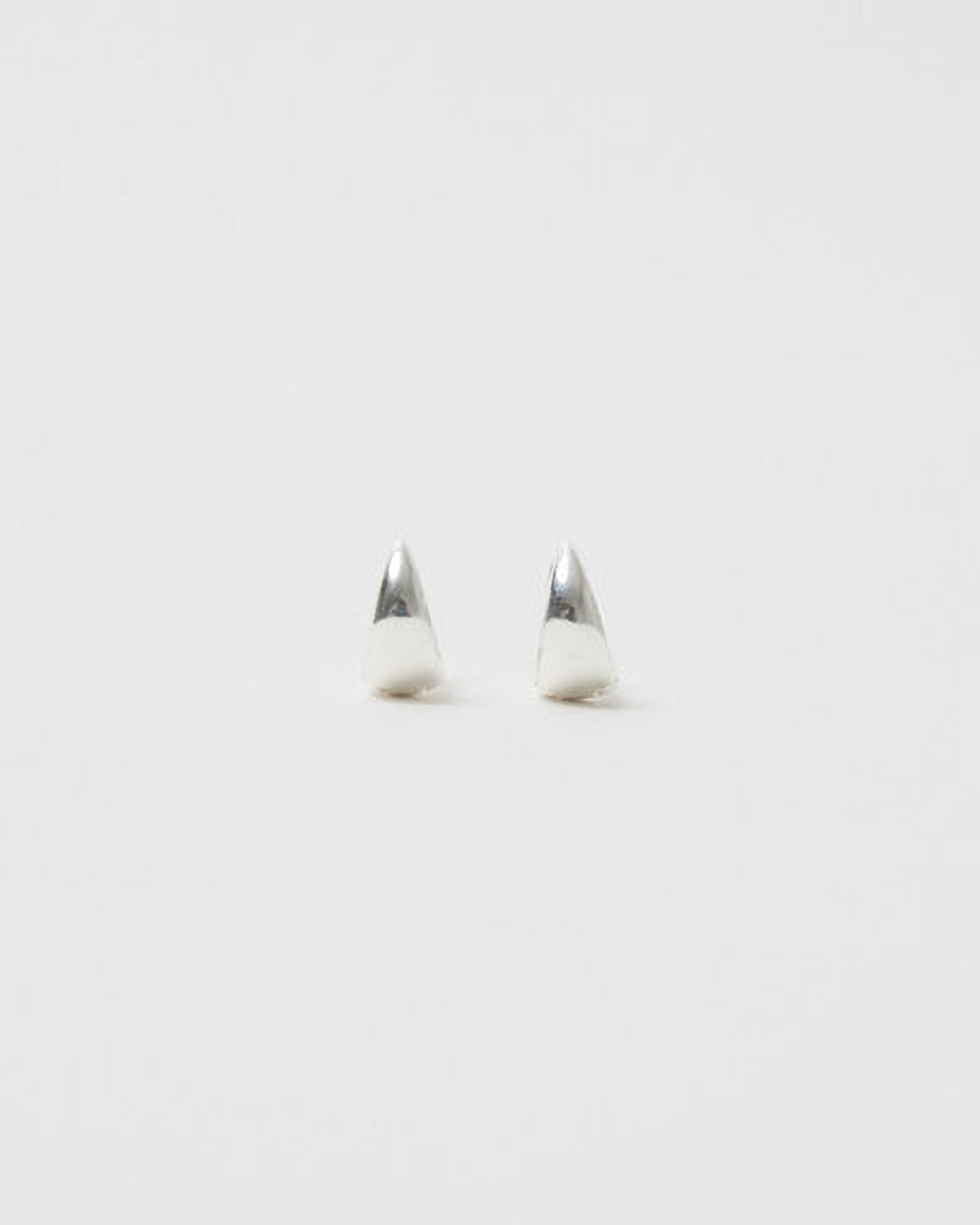 Pair of silver earrings on a light gray background