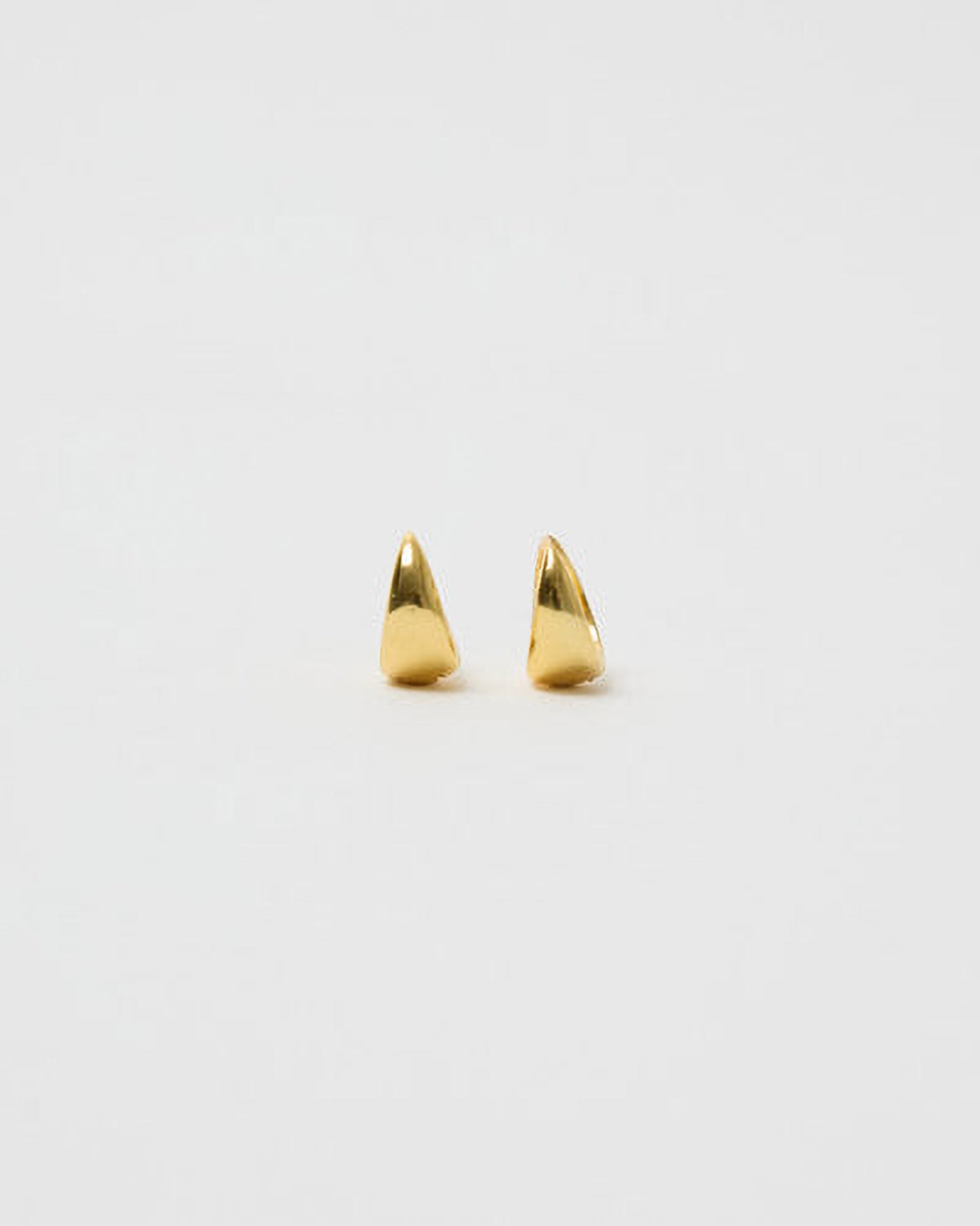 Pair of gold spike earrings on a white background