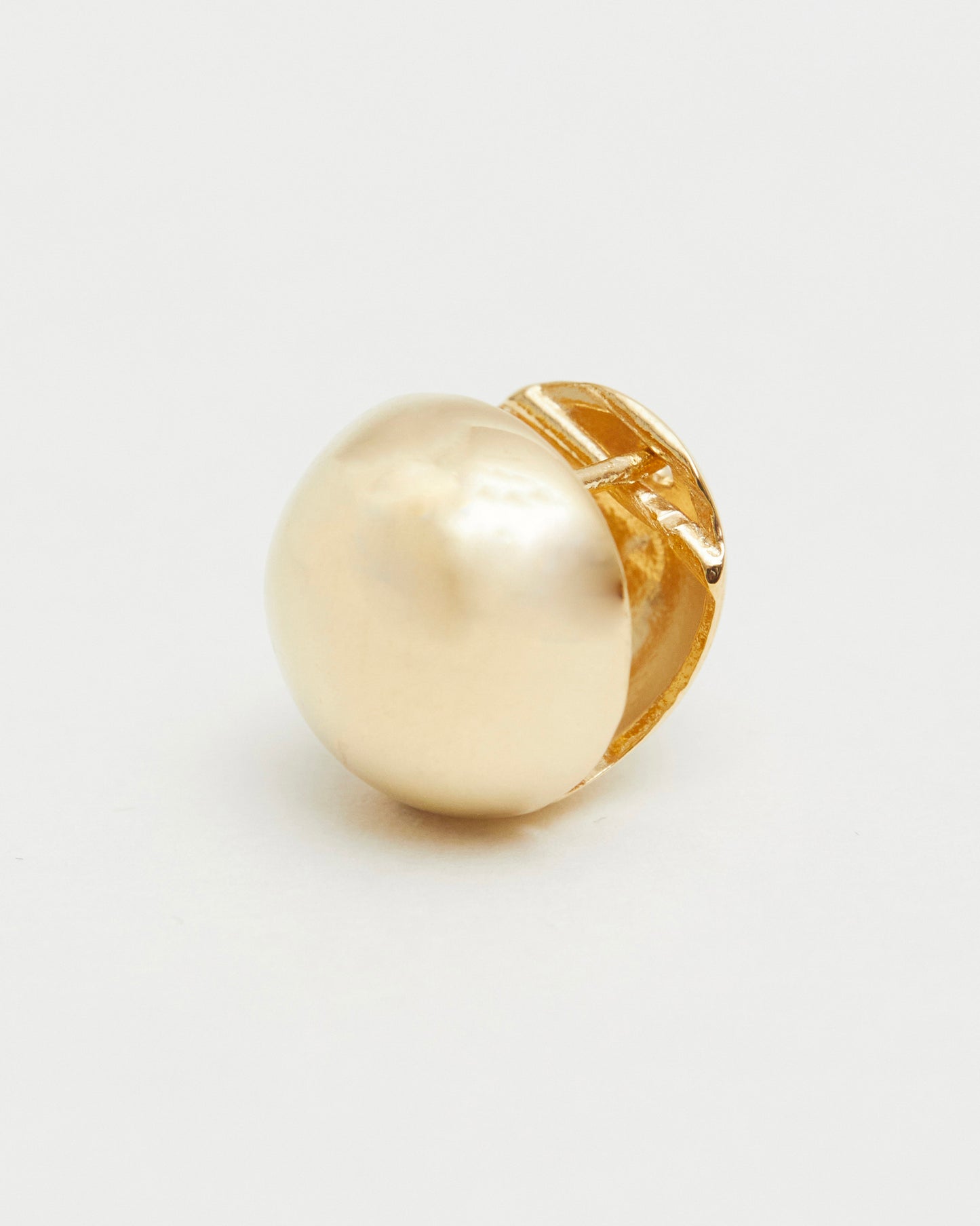 gold ring with a large pearl-like stone on a white background