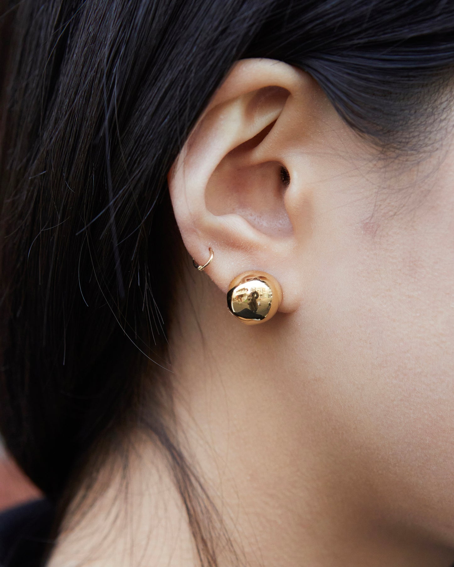 close up gold dome stud earrings reflective bold minimal statement jewelry
