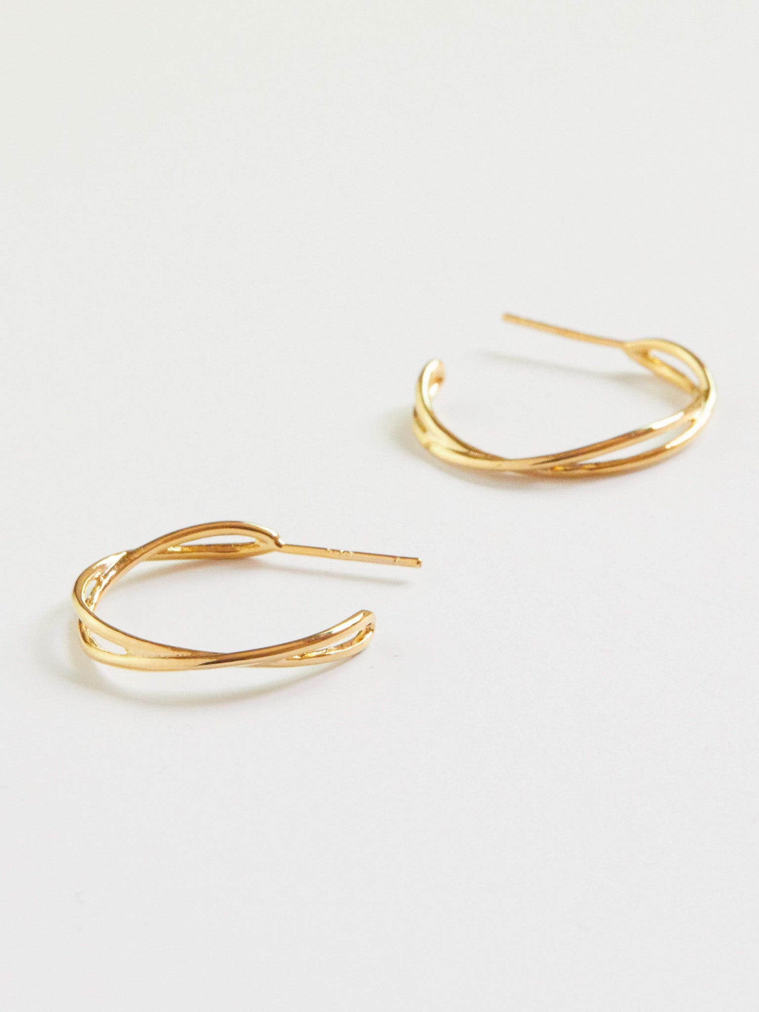 Gold hoop earrings on a white background