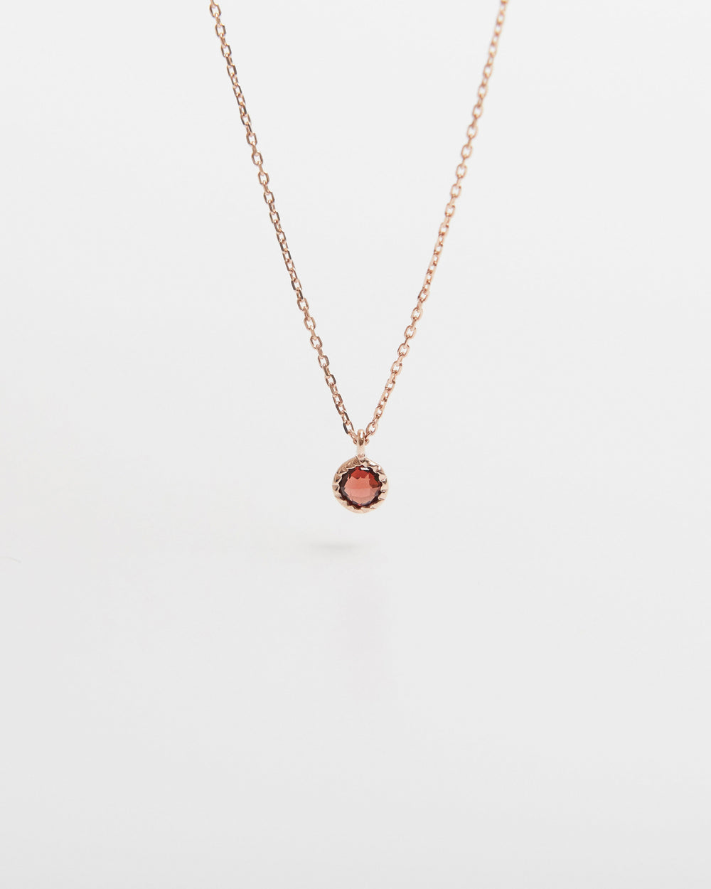 Necklace with a small round pendant on a white background