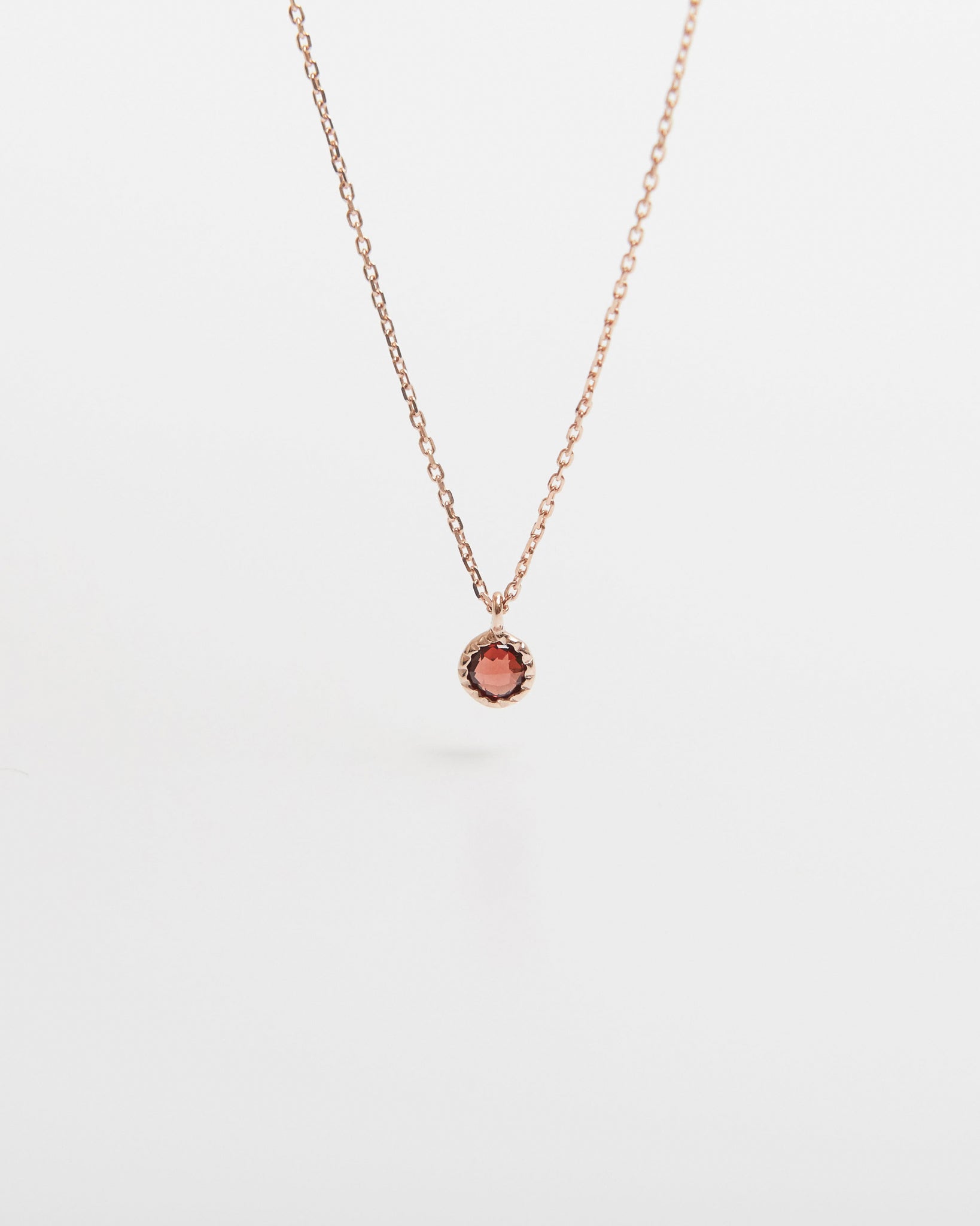 Necklace with a small round pendant on a white background