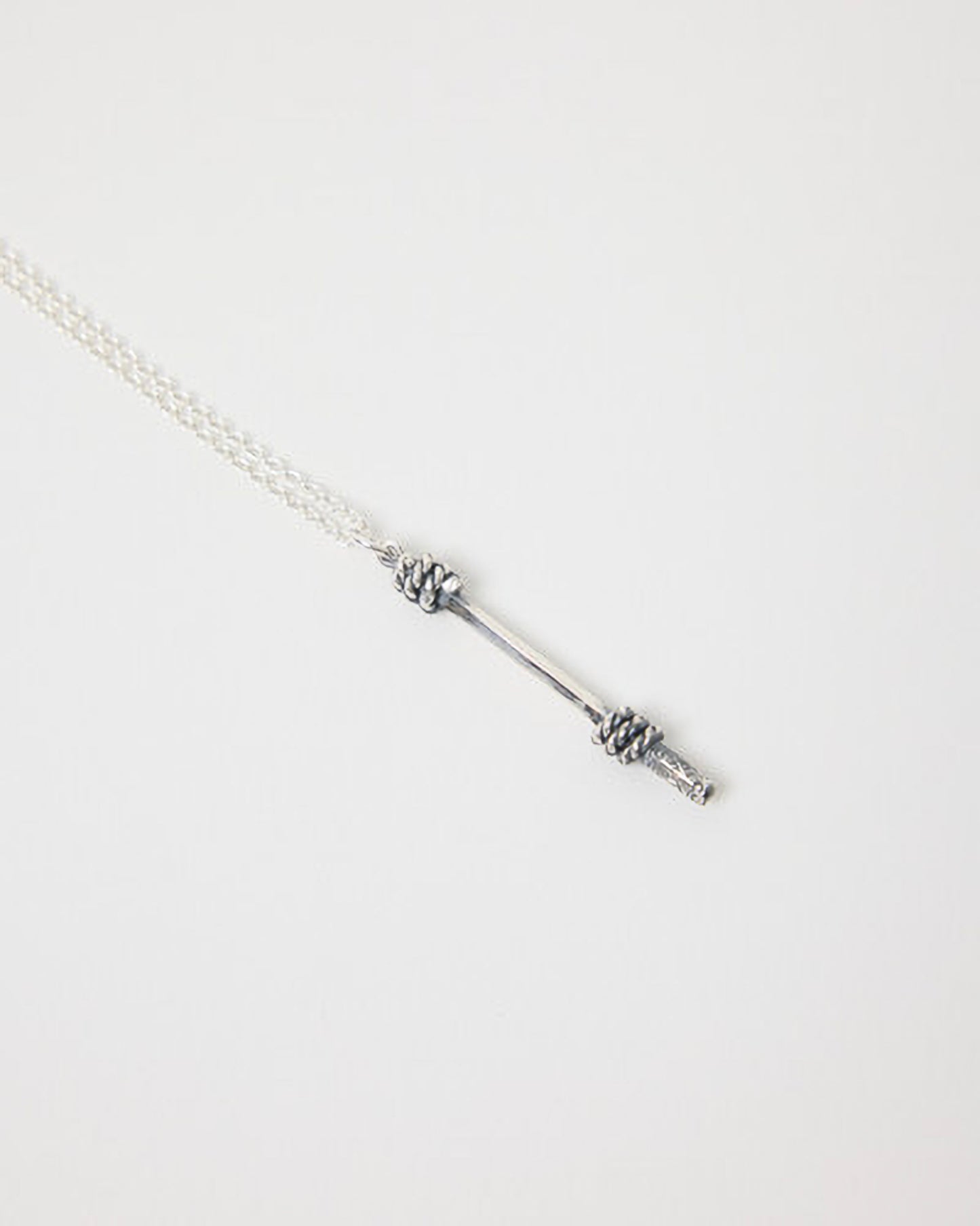 Silver bracelet with a unique design on a light gray background