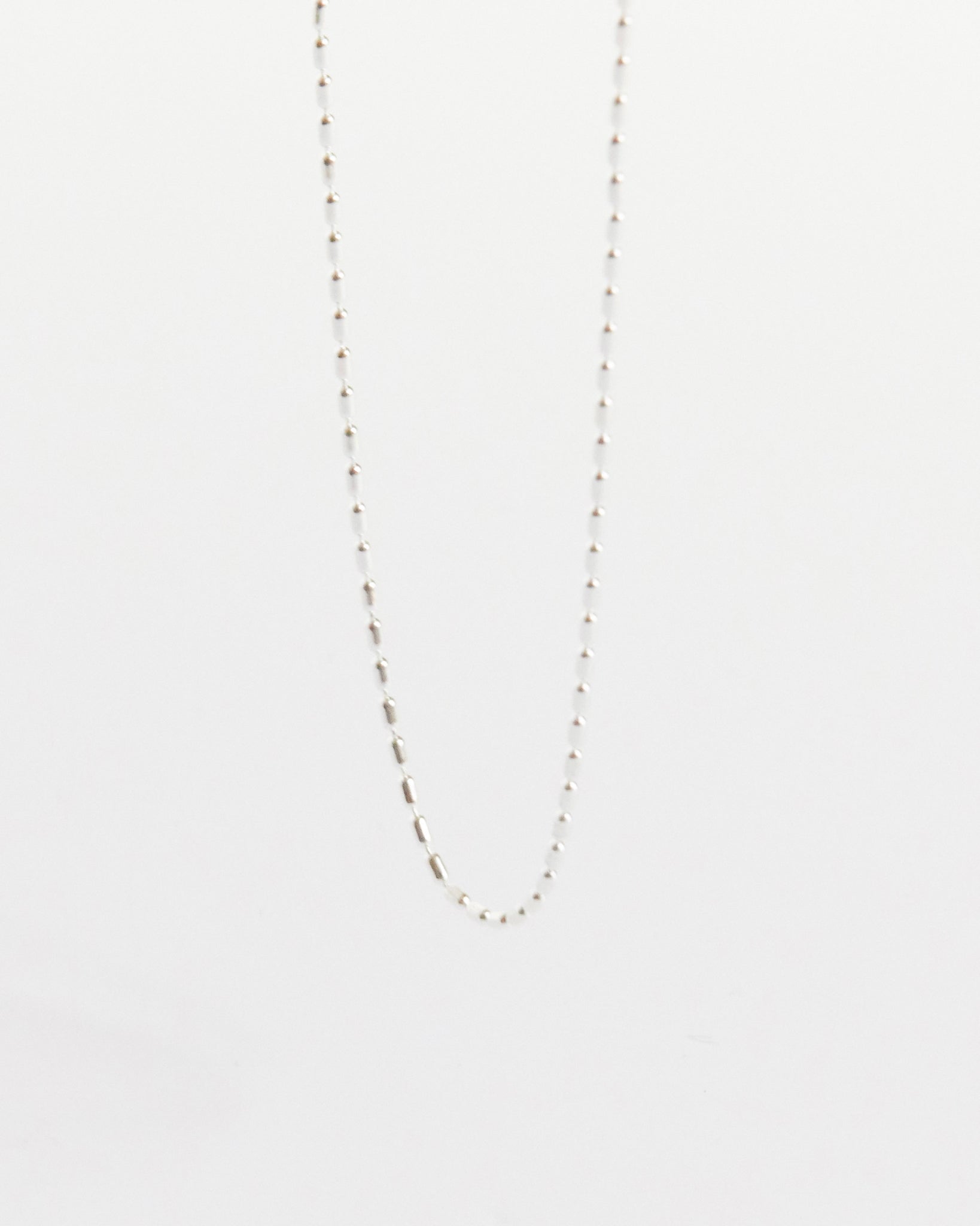 a soft silver line across the collarbone doing just enough (and never too much)