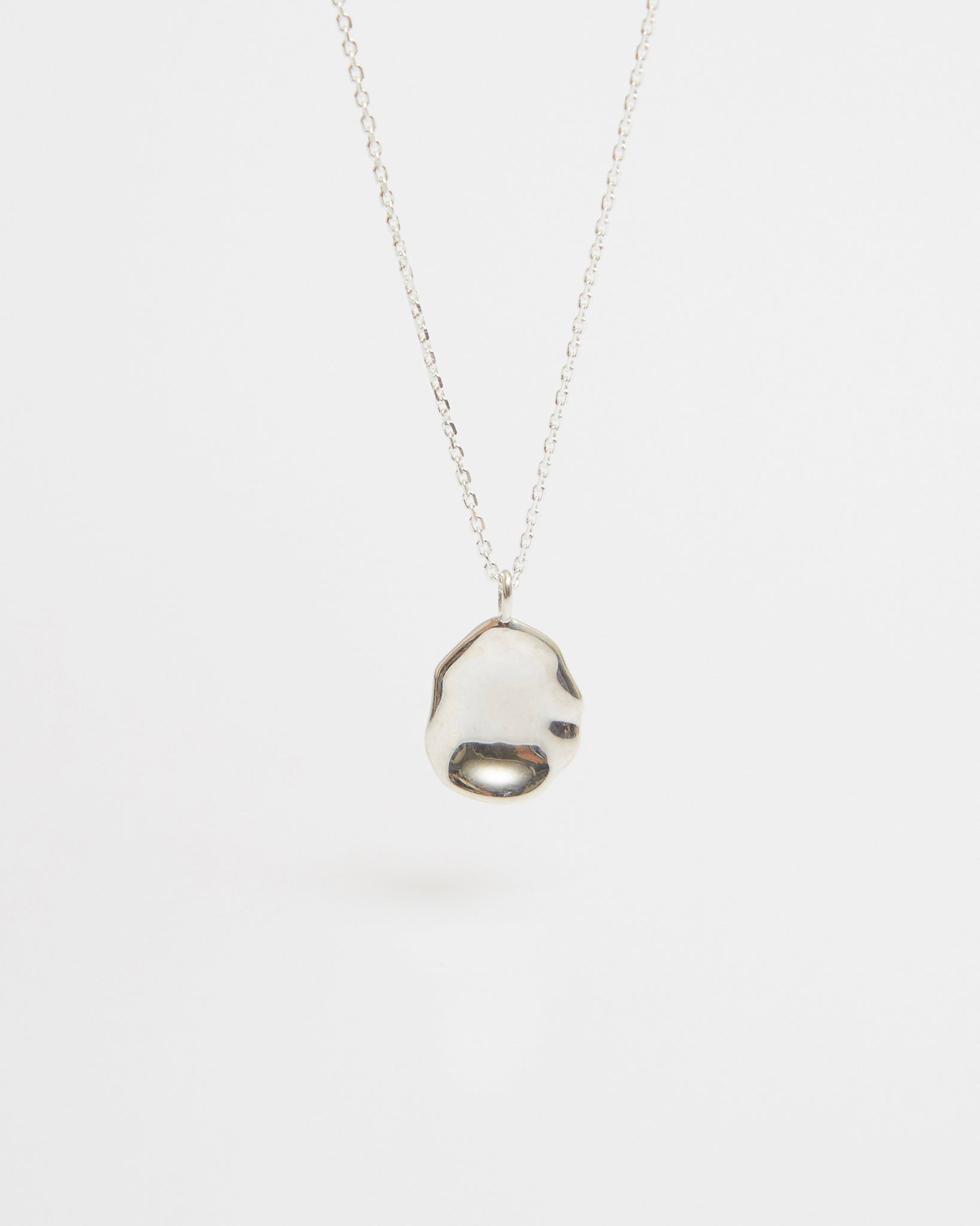 Silver pendant necklace on a white background