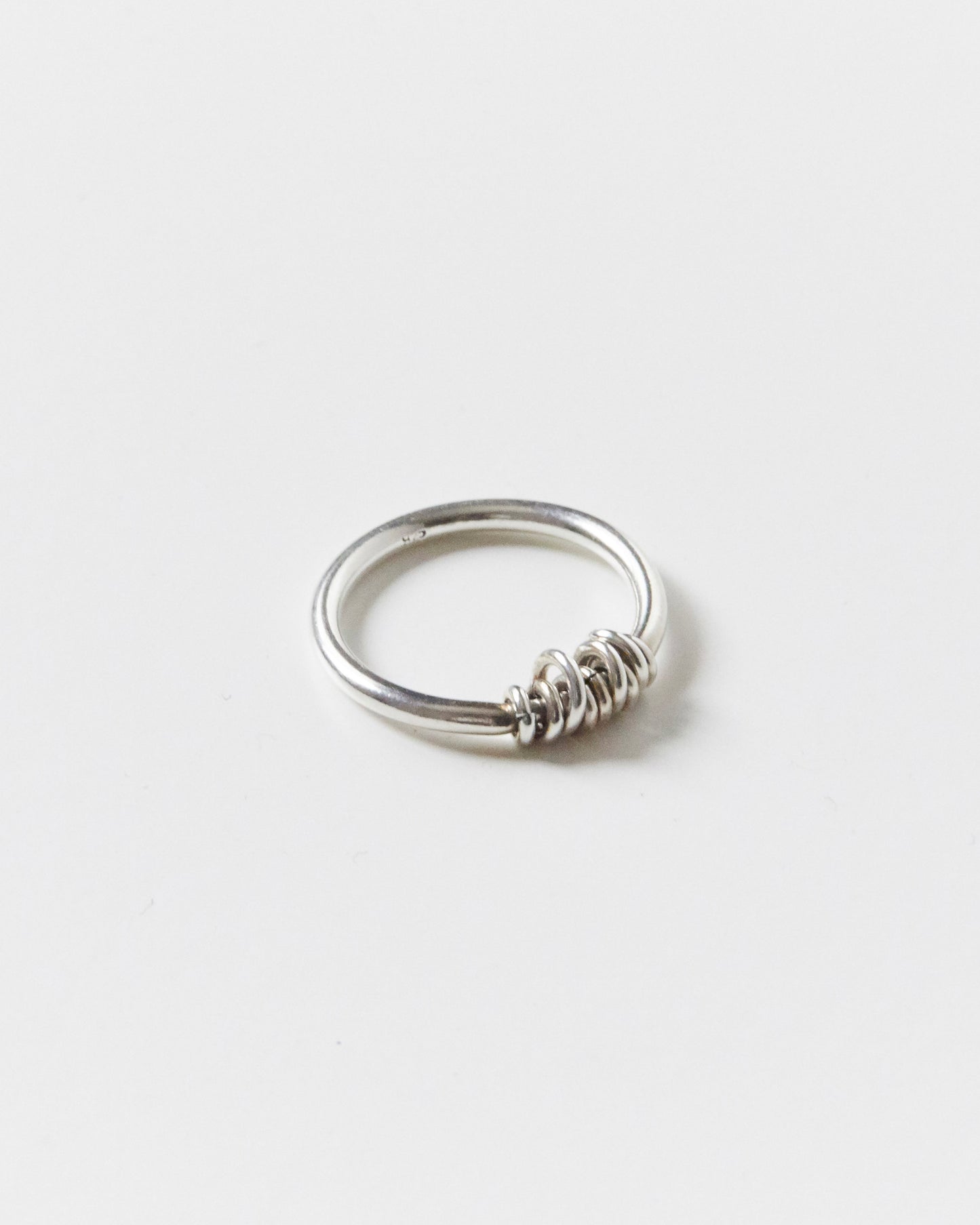 stacked sterling silver rings casually stealing attention while pretending to be effortless