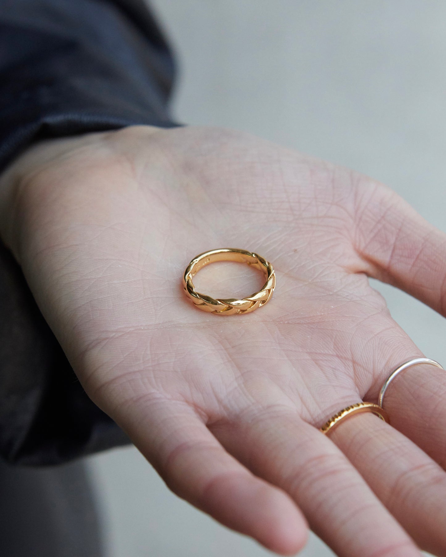 Gold ring on a person's hand with a blurred background