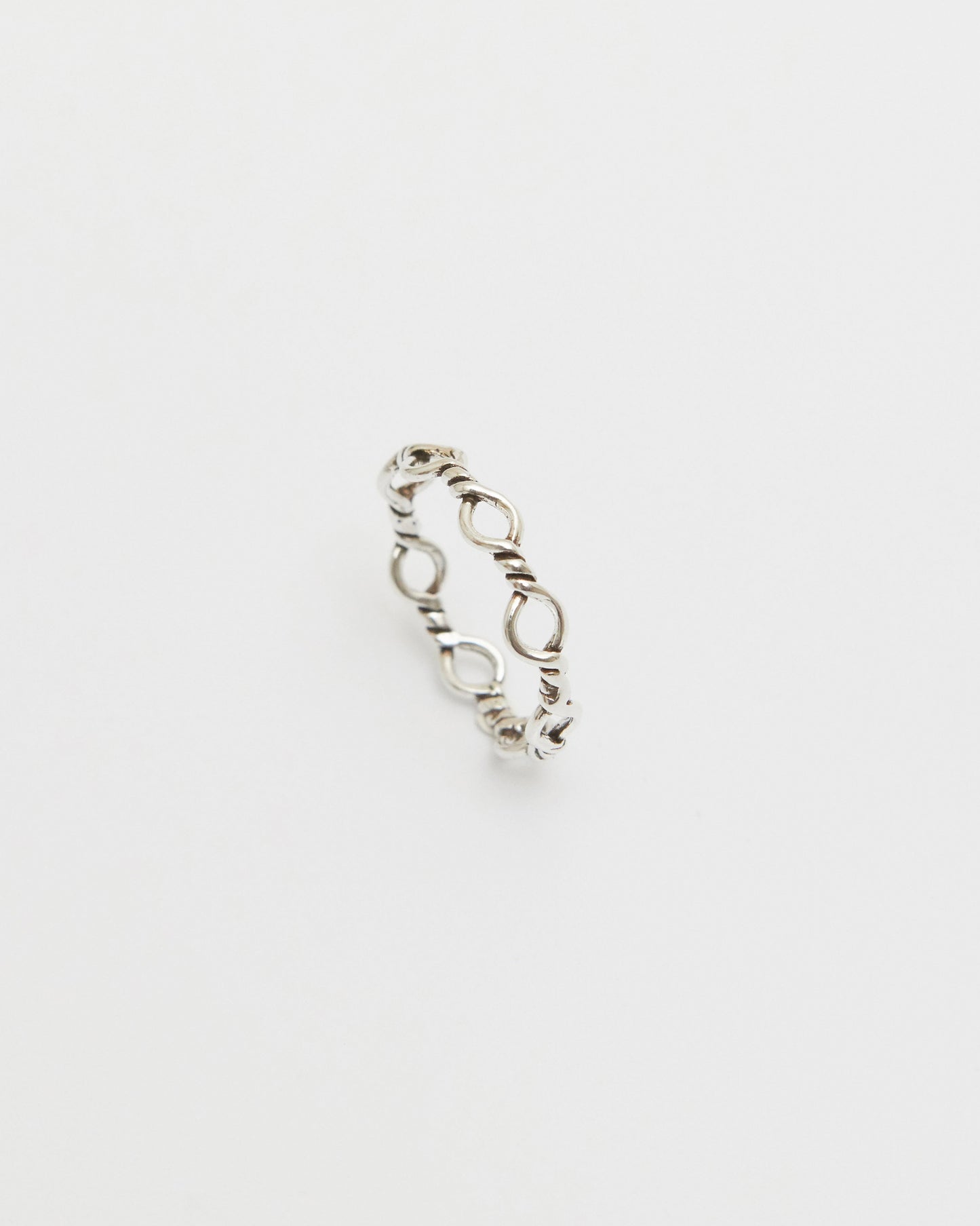 silver loop ring styled on hand with casual denim, modern editorial jewelry look