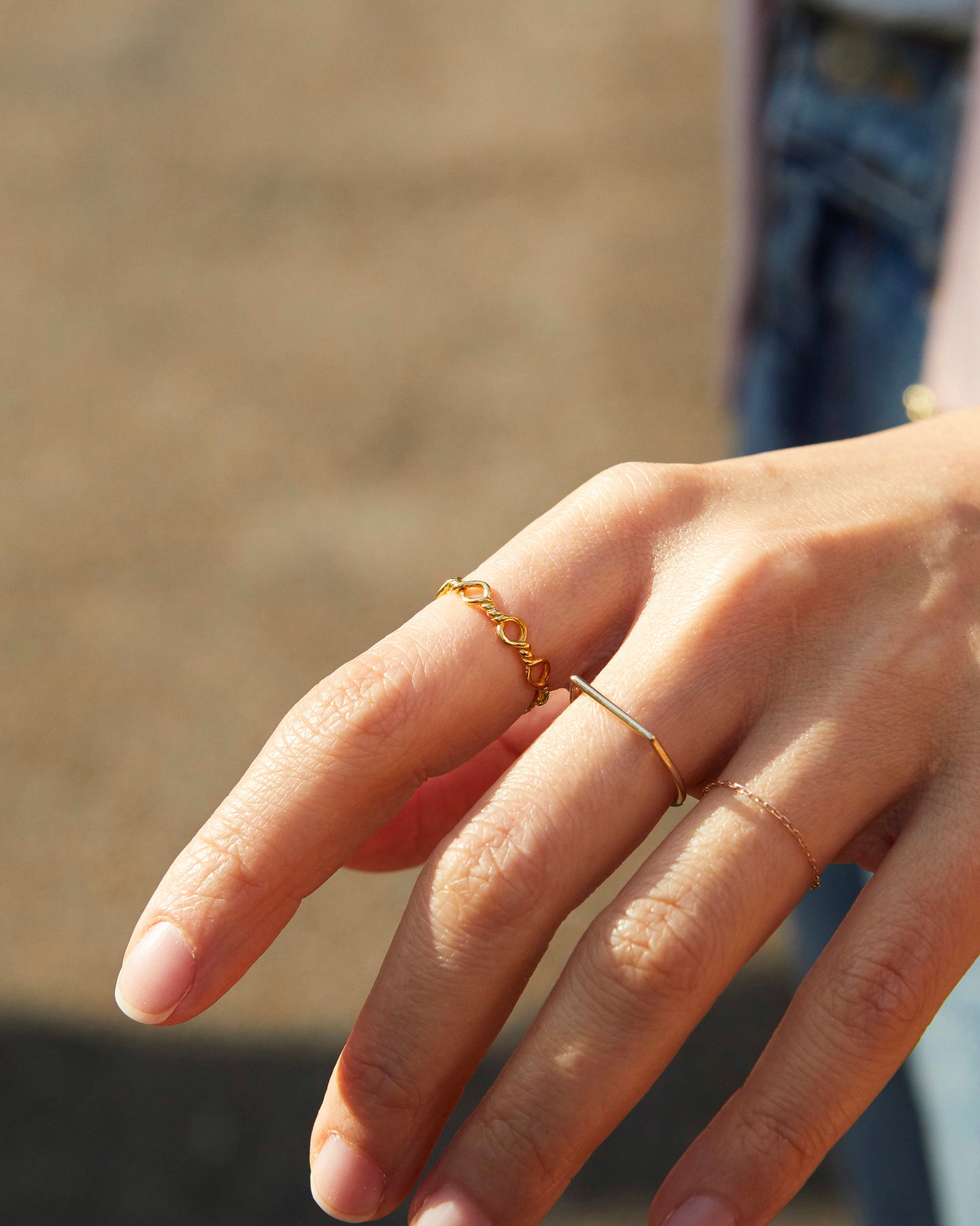 conceptual gold ring with repeated loop elements, minimal art-inspired jewelry