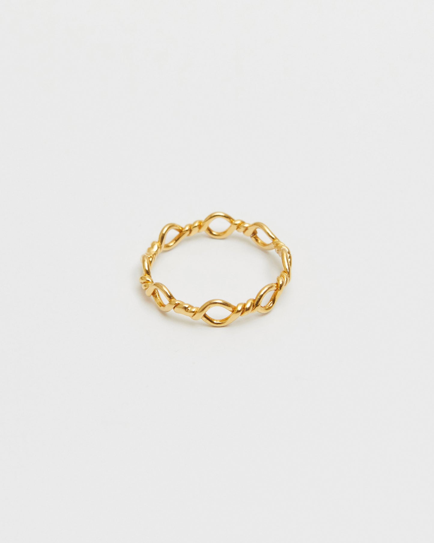 architectural gold ring composed of interlinked loop forms, geometric and minimal design