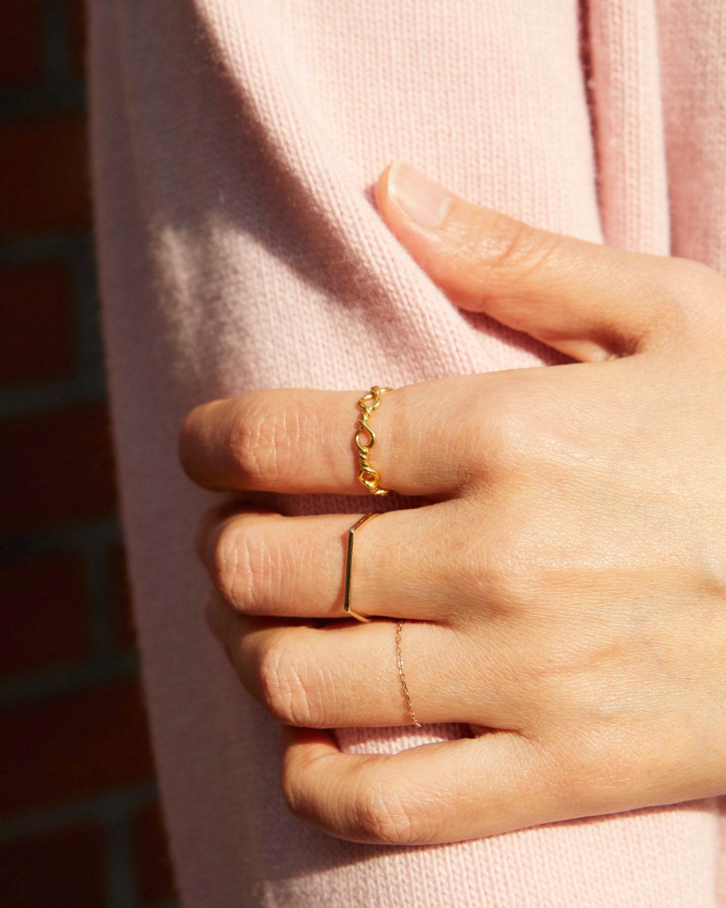 conceptual gold ring with repeated loop elements, minimal art-inspired jewelry