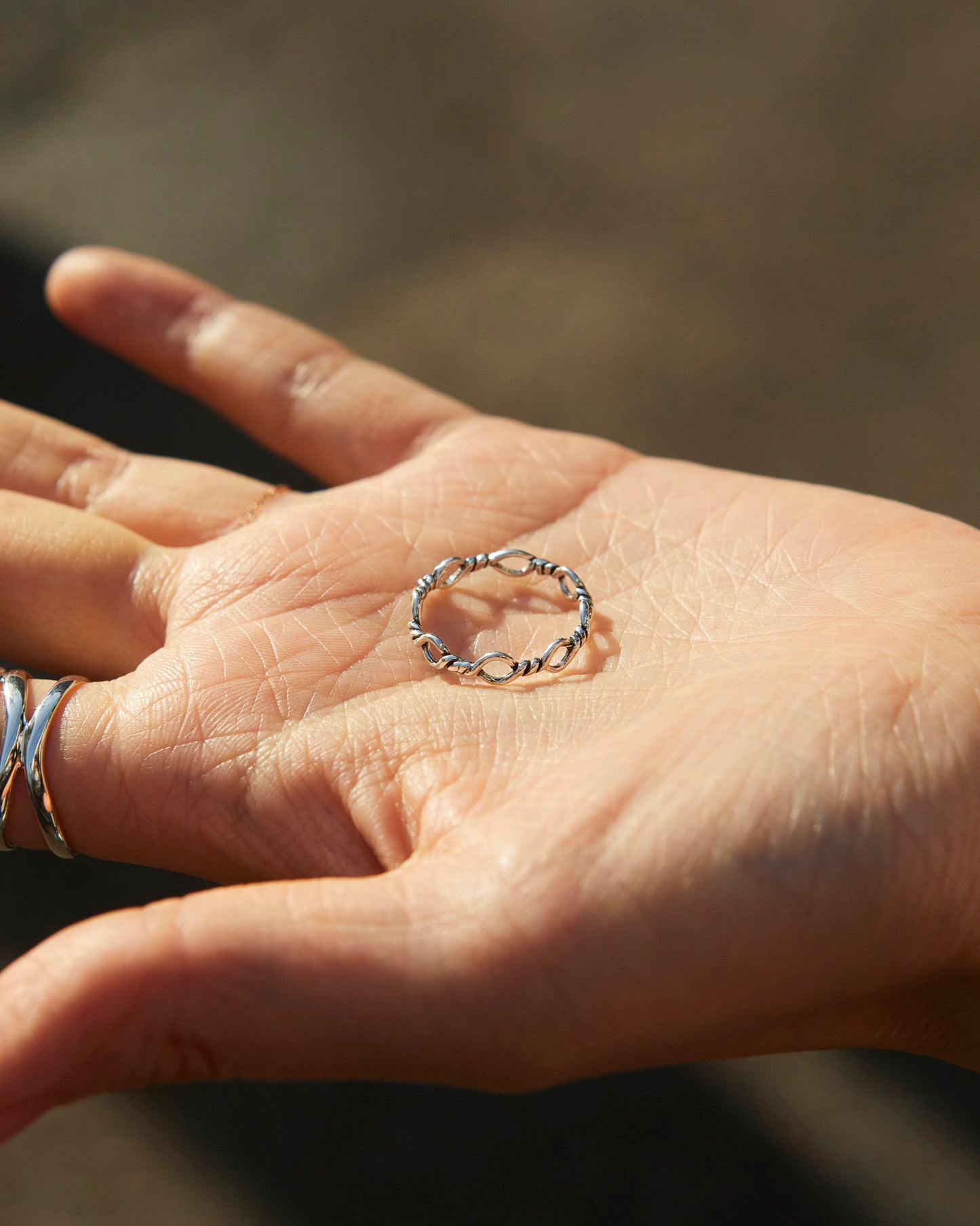 polished silver loop ring highlighting smooth texture and refined metal surface