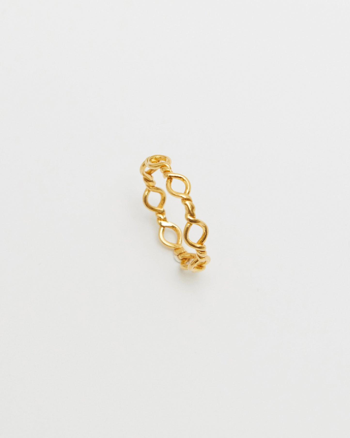 gold loop ring styled on hand with casual denim, modern editorial jewelry look