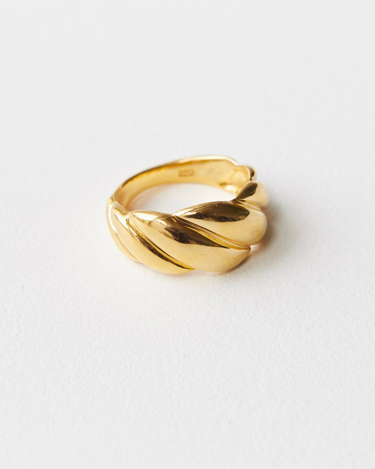 architectural twisted ring with sculpted volume and continuous curved form in polished metal