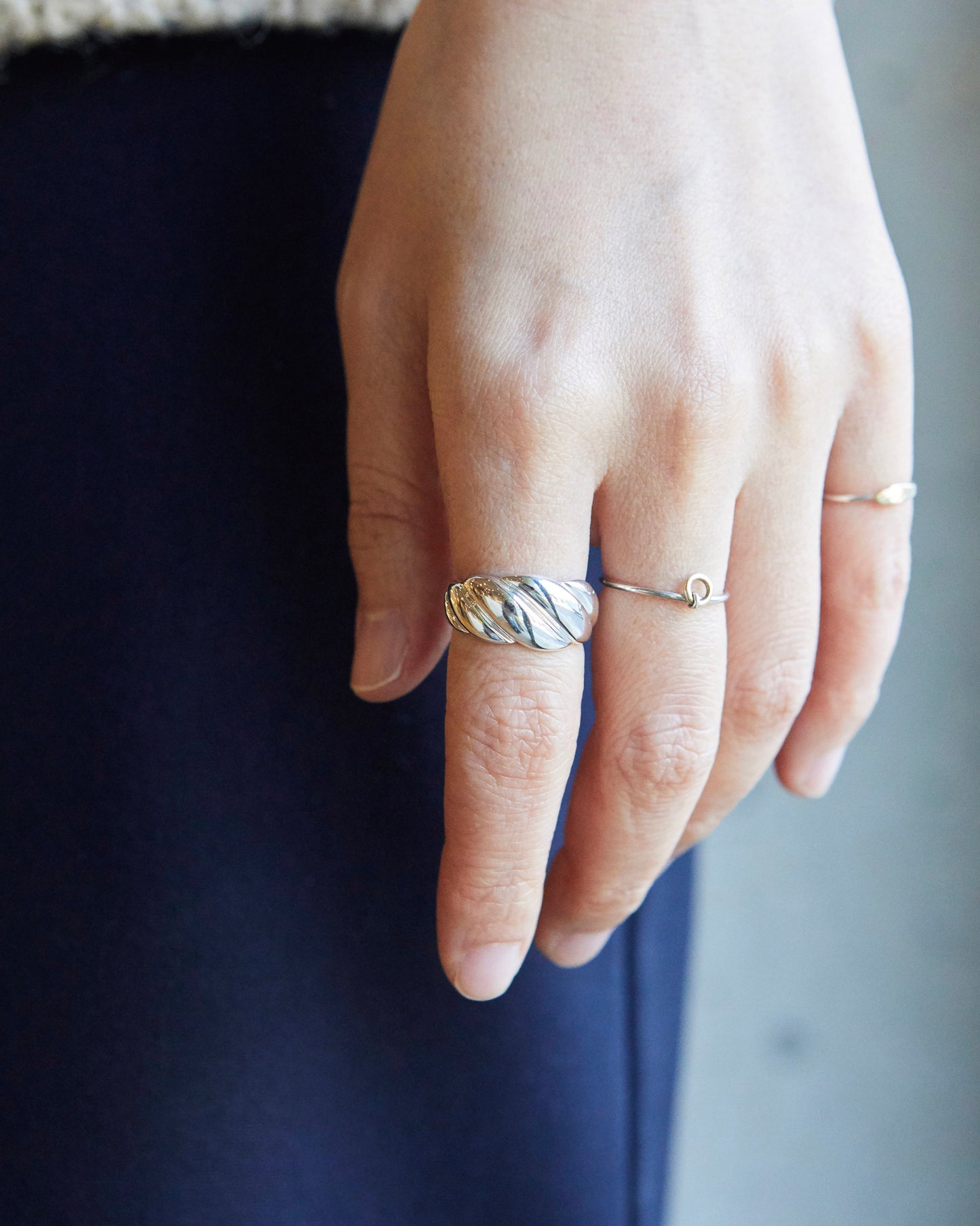 chunky twisted ring worn on finger, smooth edges and comfortable fit