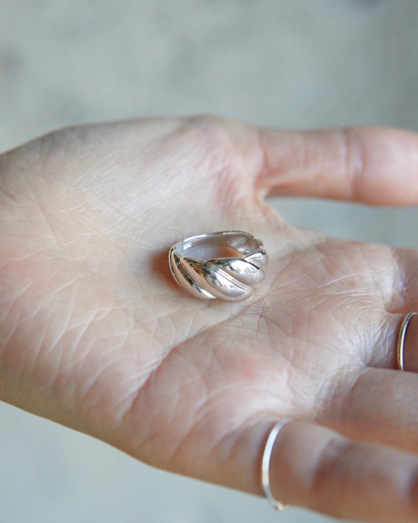 polished twisted ring highlighting smooth metal surface and sculpted volume