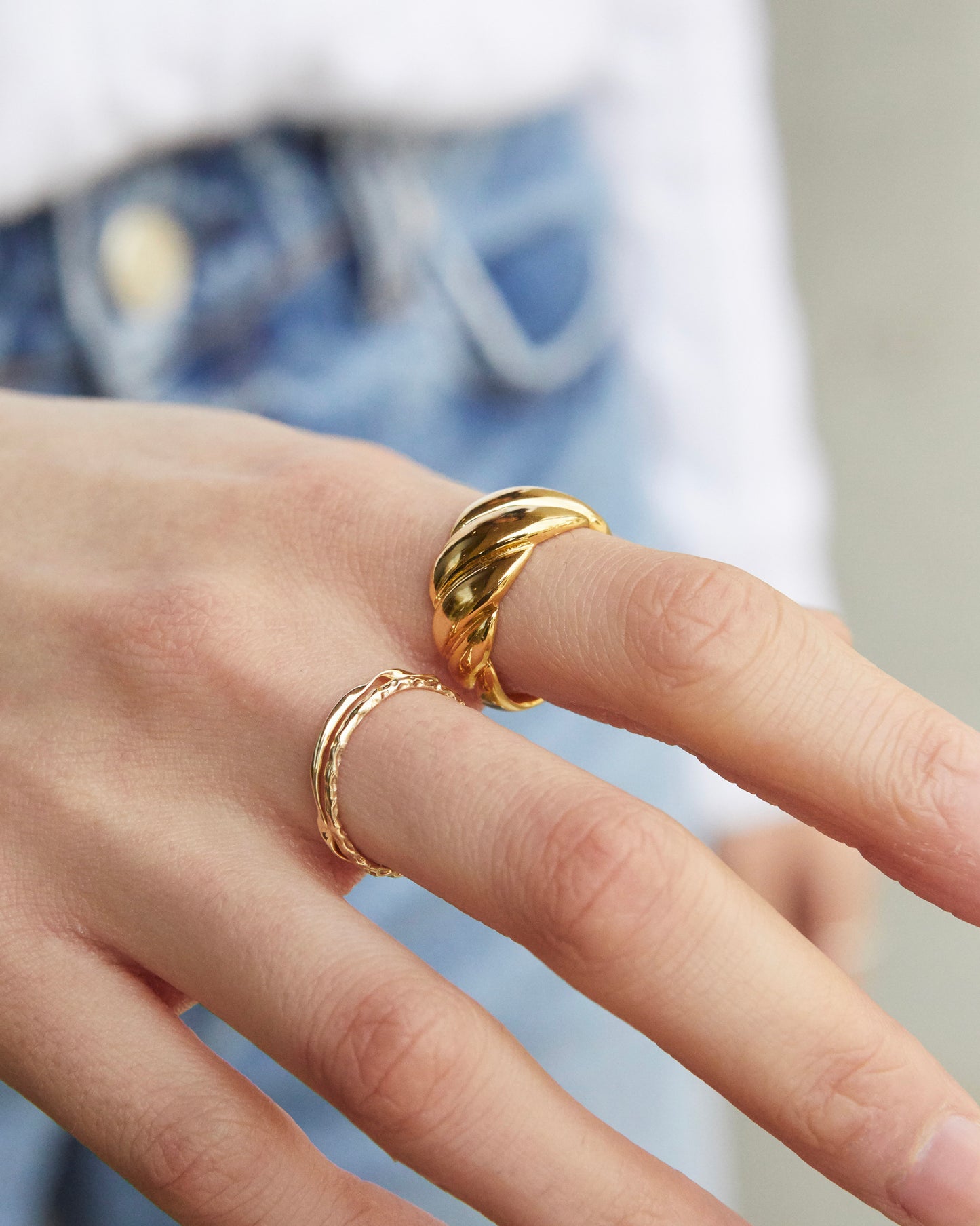 twisted metal ring with playful sculptural curve, modern minimalist jewelry