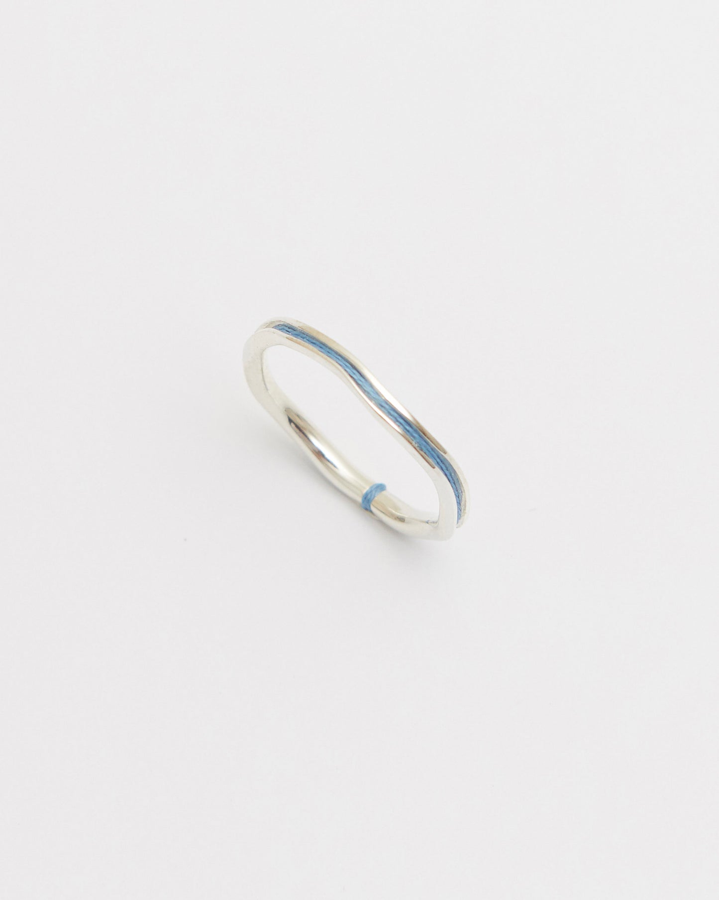 Silver ring with sky blue on a white background