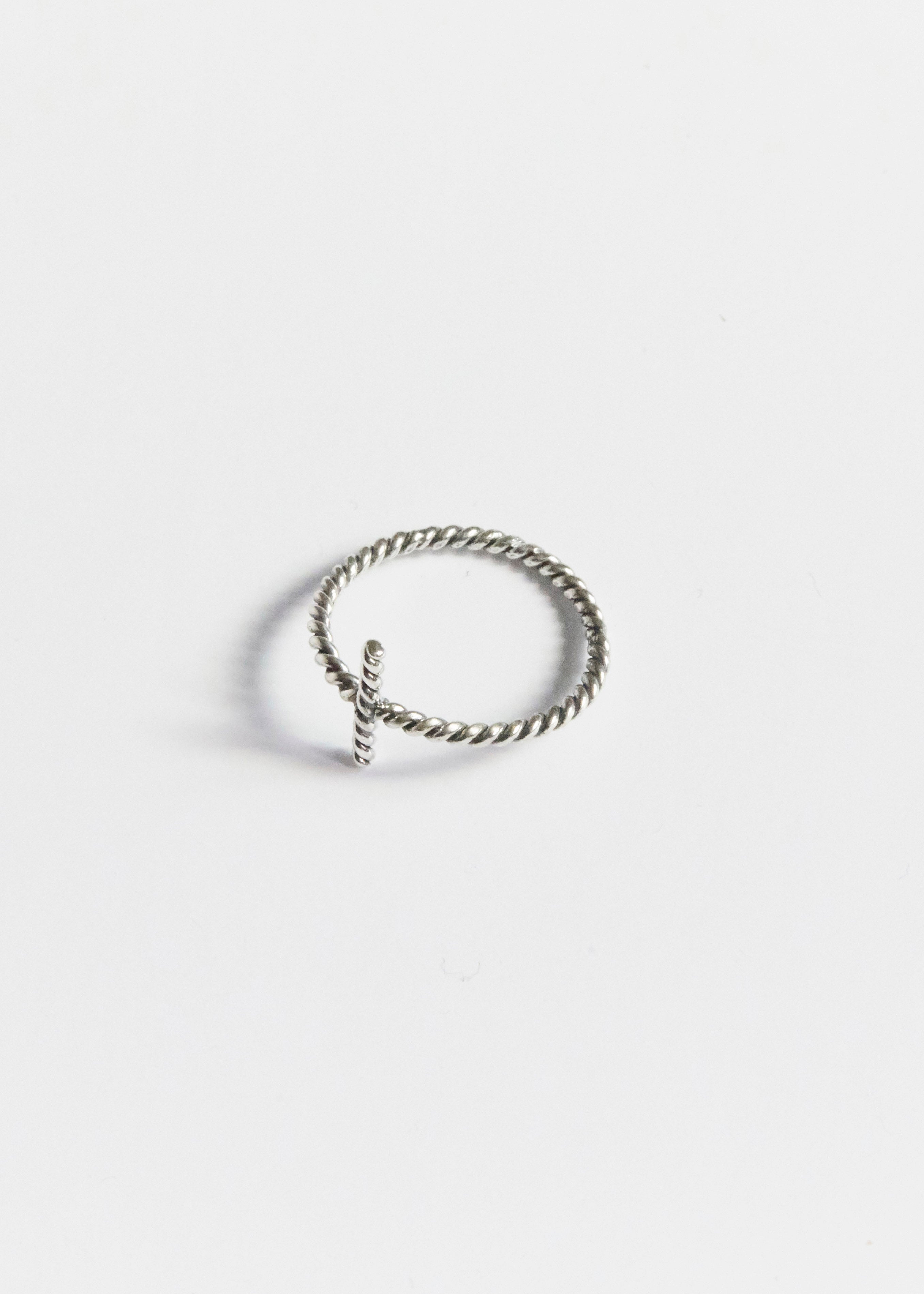 a tiny cross ring quietly doing all the emotional heavy lifting