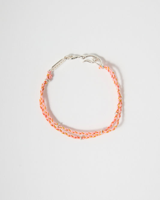 Close-up of handwoven pink bracelet featuring sterling silver details
