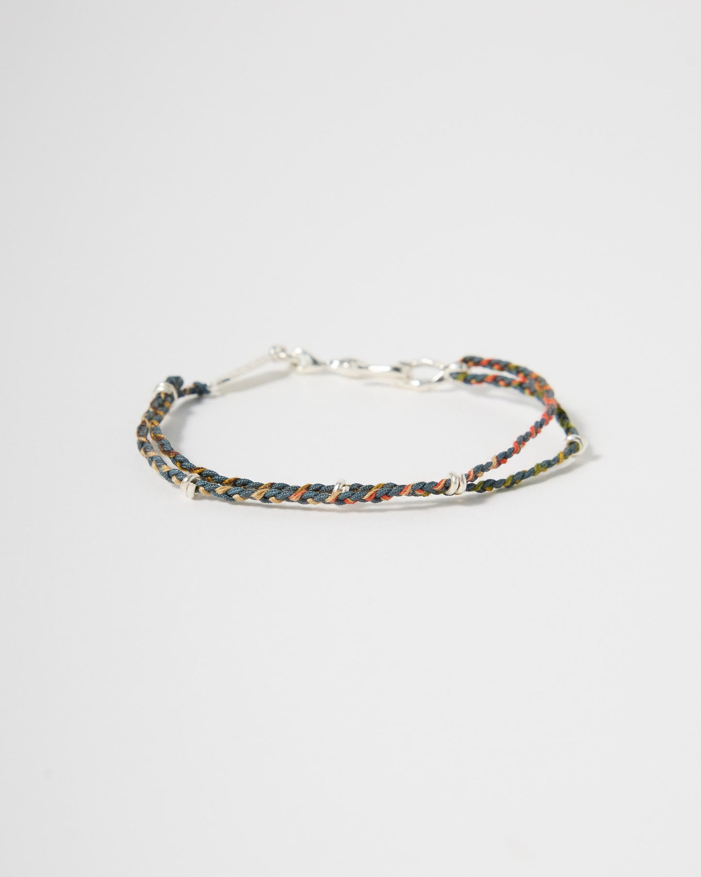 Handwoven earth-tone cord bracelet with sterling silver accents and clasp, minimalist everyday jewelry